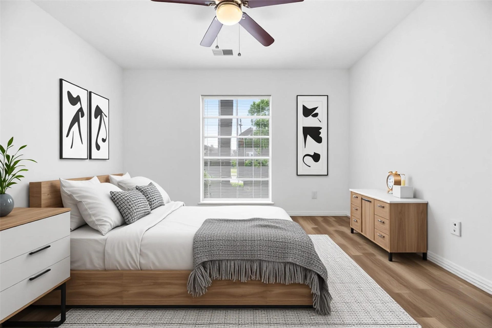 *virtually staged* Secondary bedroom complete with wide plank LVP floors, large window, and ceiling fan.
