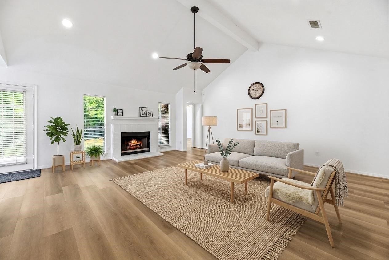 *virtually staged* beautiful living room with high ceilings, fresh paint, recessed lights, and wide plank LVP floors.