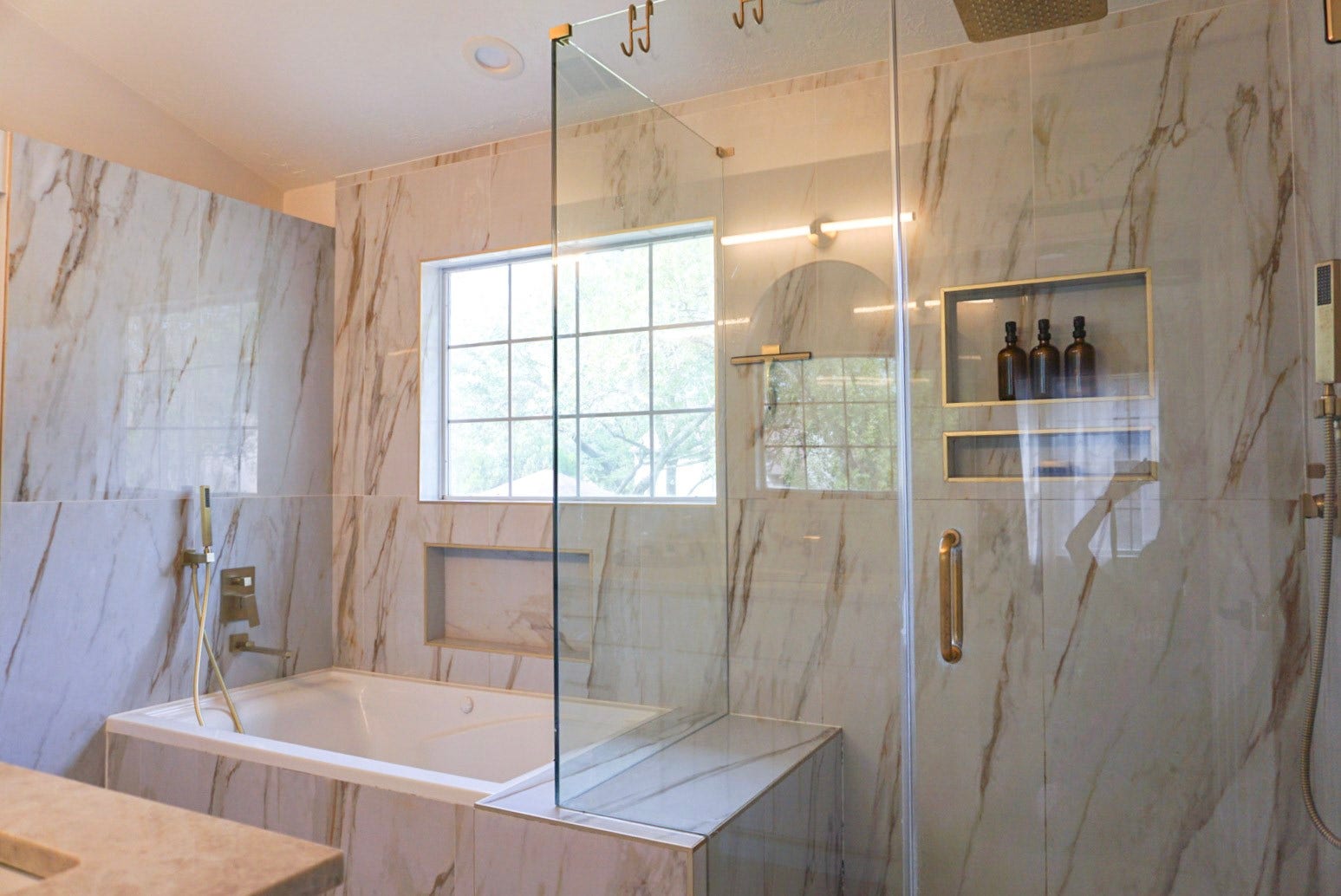 16910 Poplar Hill Street, Houston, TX 77095 Walk-in rainfall shower with bench and hand-held attachment, jetted tub with Roman faucet, full tiled wall