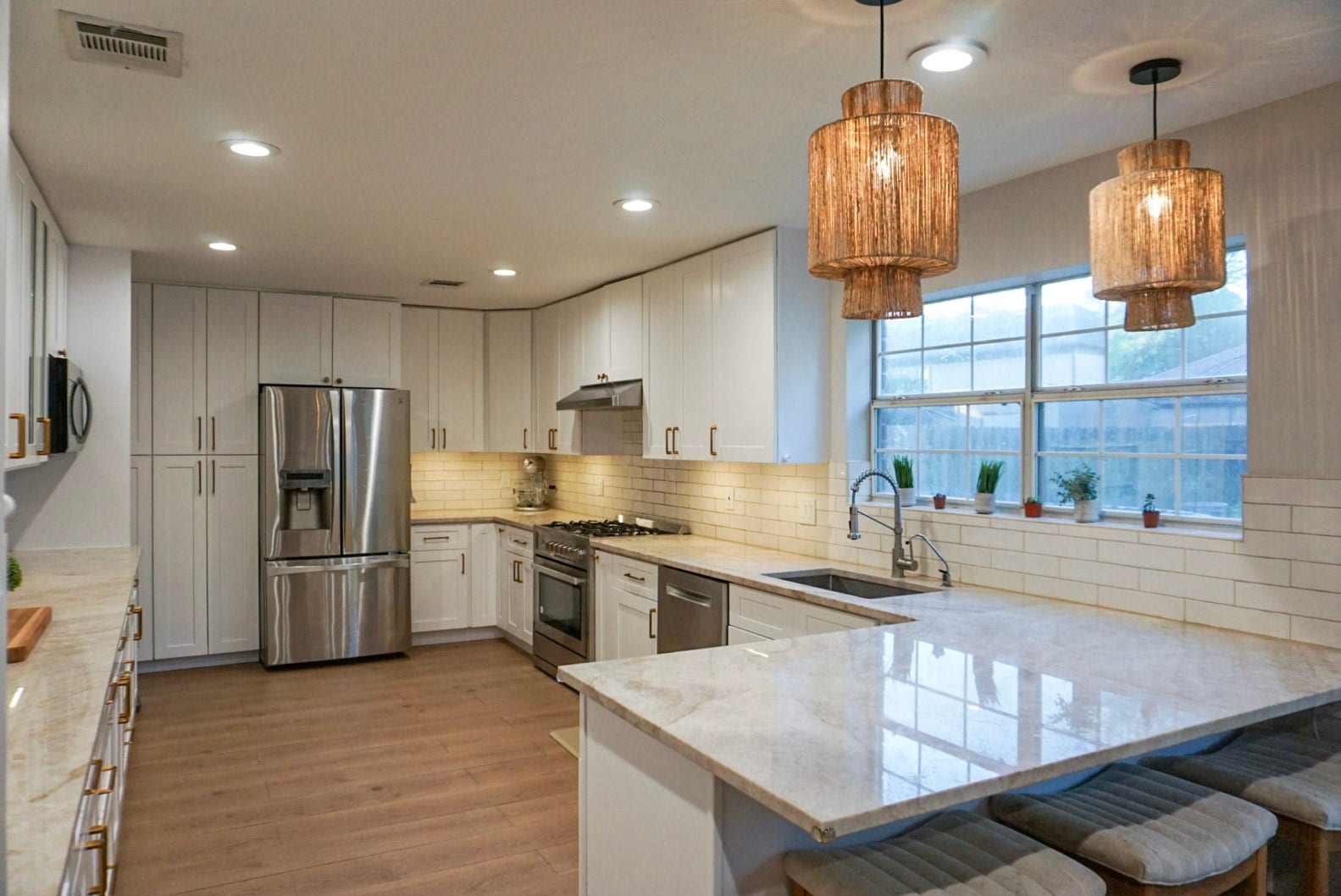 16910 Poplar Hill Street, Houston, TX 77095 Taj Mahal Quartize countertops, custom cabinetry, rattan pendant lights, LED lights
