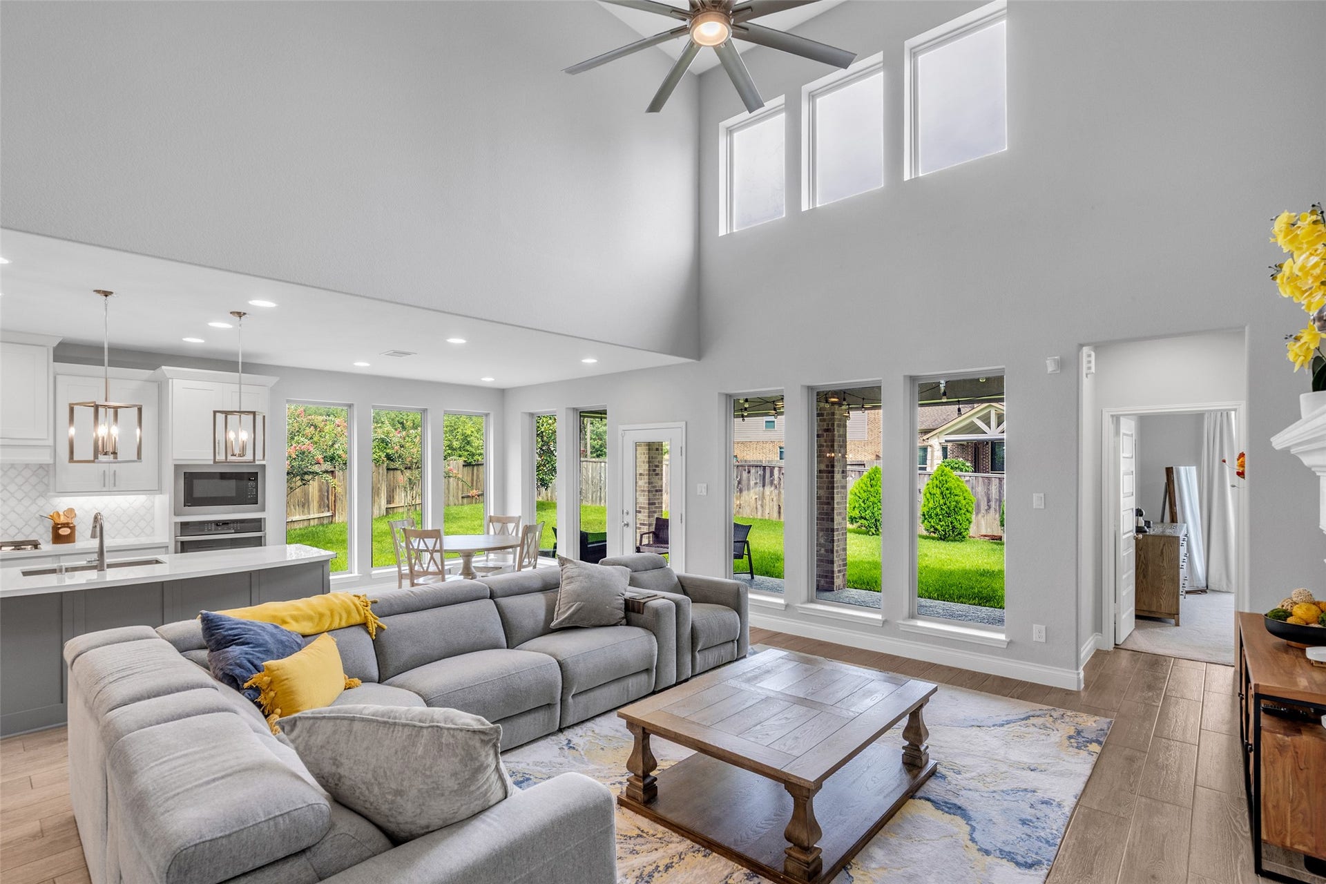 Two-story family room with wall on windows & fireplace