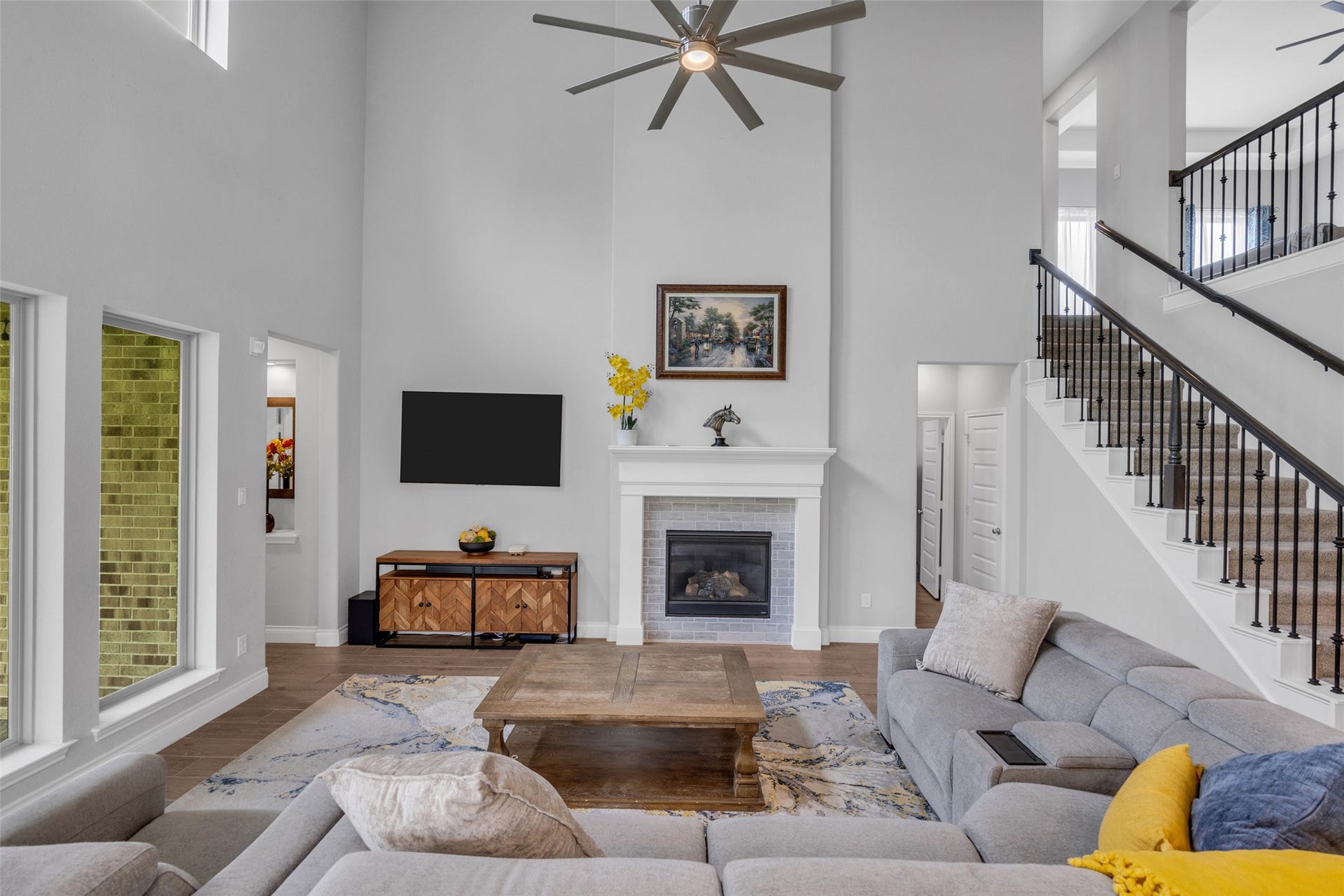 Two-story family room with wall on windows & fireplace