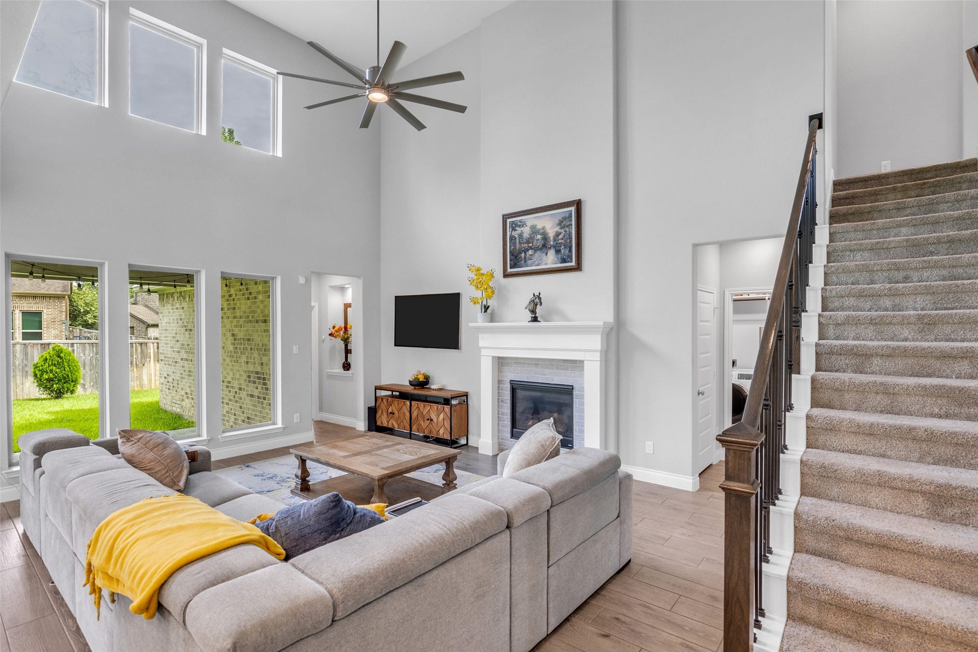 Two-story family room with wall on windows & fireplace