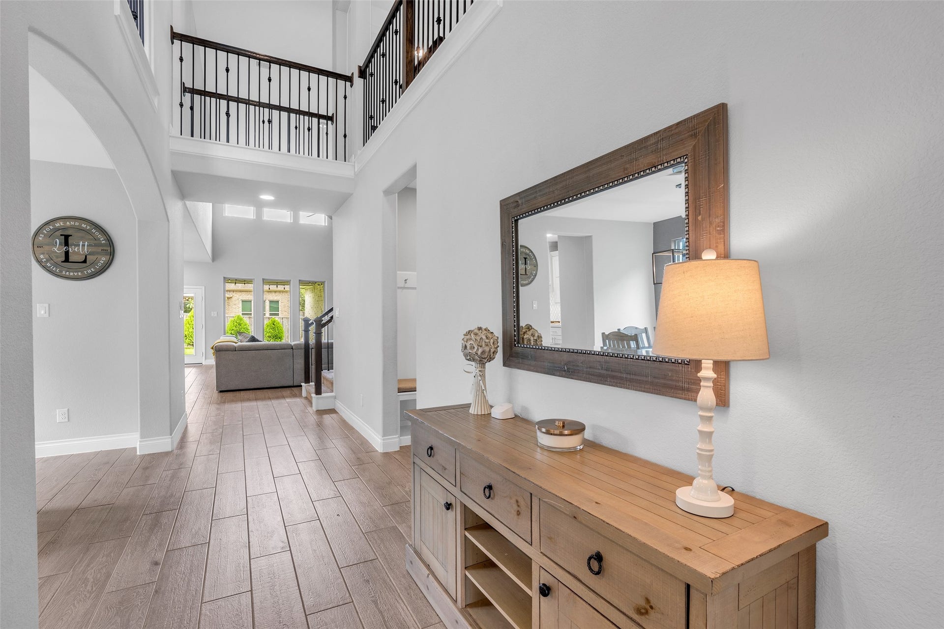 Grand foyer and wood look tile throughout downstairs.
