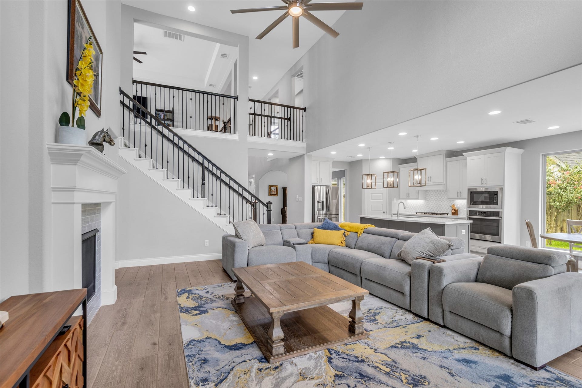 Two-story family room with wall on windows & fireplace