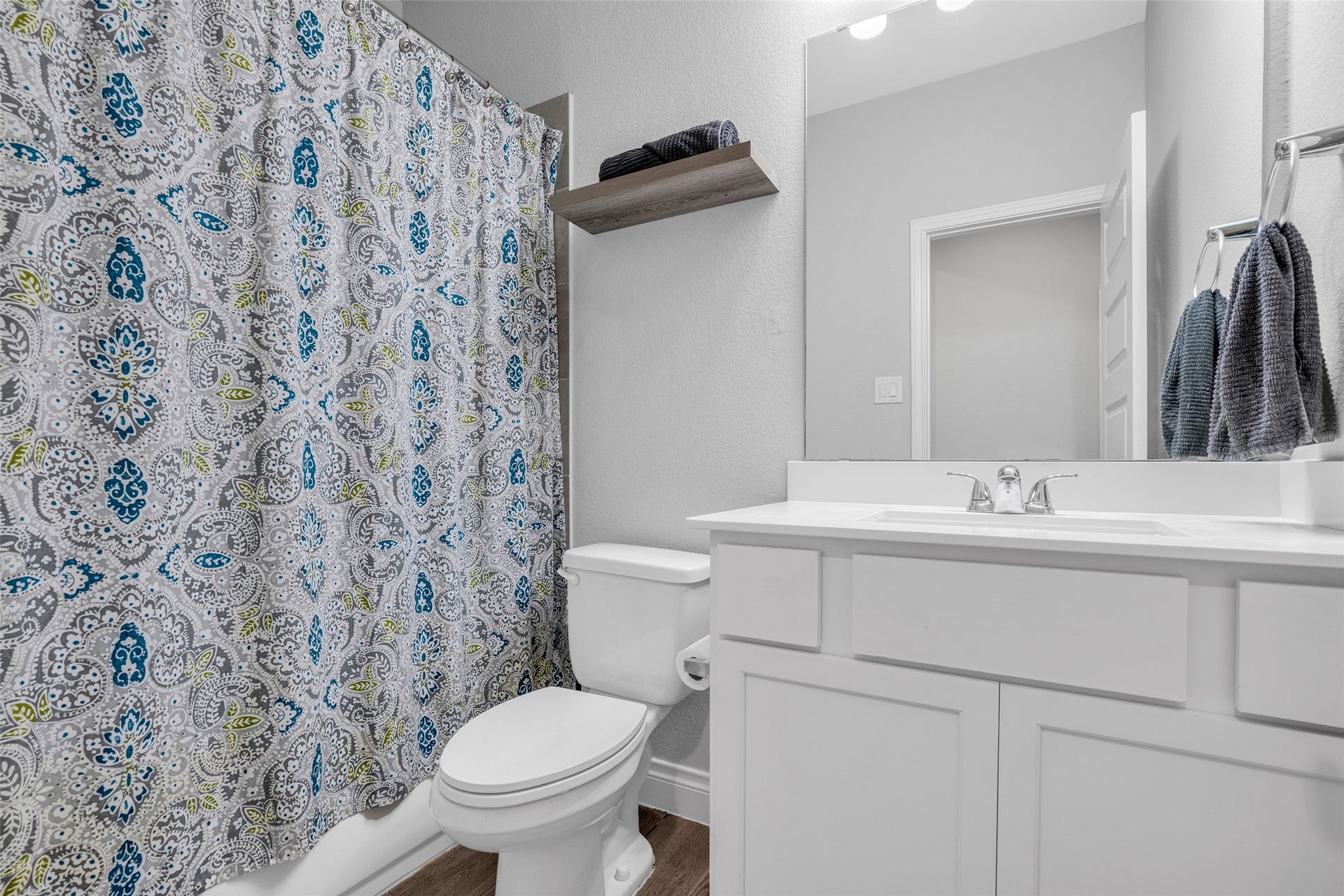 Full bath downstairs next to secondary bedroom
