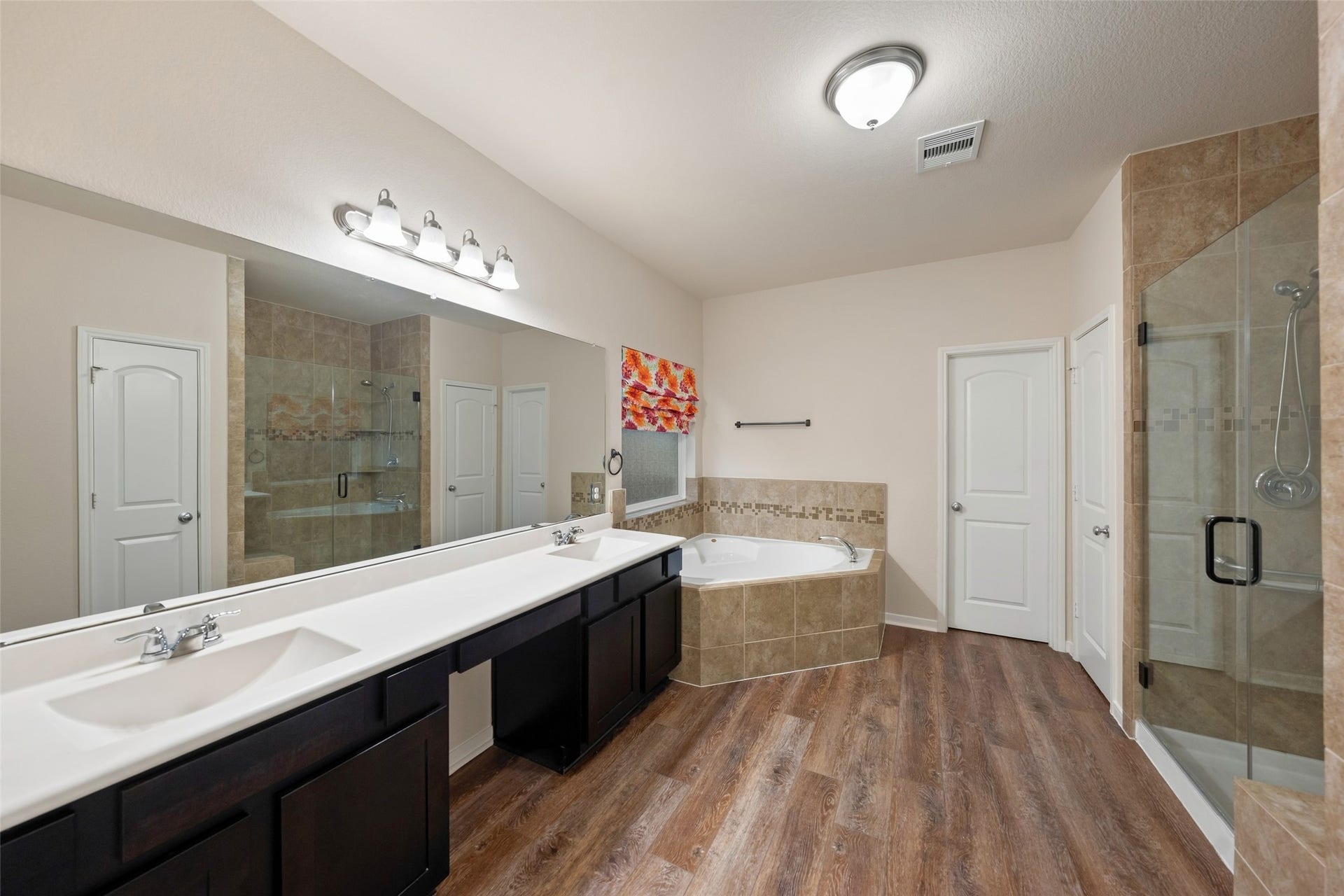 5182 Echo Falls Drive, Alvin, TX 77511 Spacious, double vanity primary bathroom with soaking garden tub and separate shower bathroom with sepa