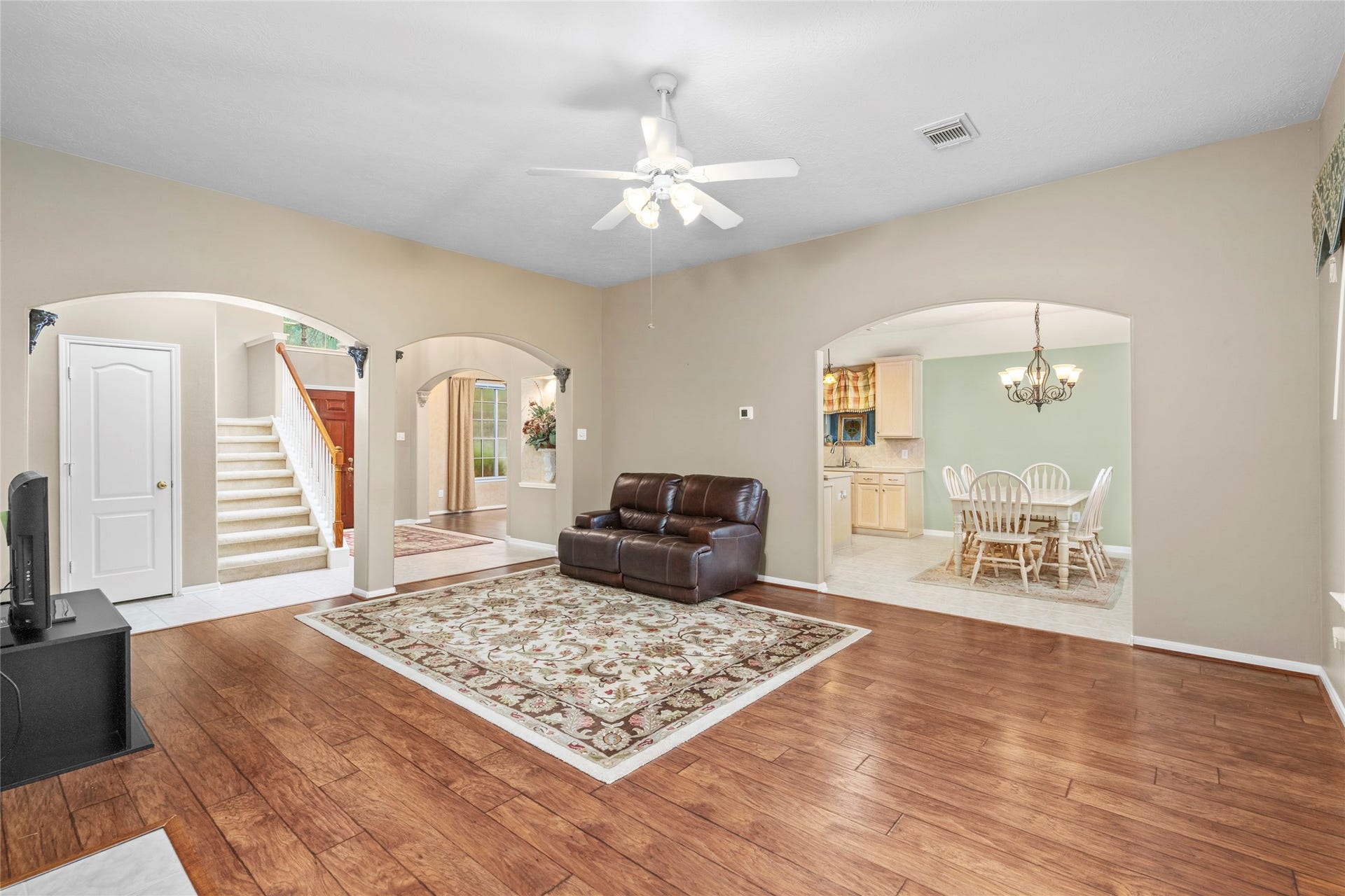 Open perspective showing how the main living area flows naturally toward the dining and kitchen spaces. The architectural openings and abundant light make the layout feel connected rather than closed off, giving the home excellent potential for entertaining and family life.