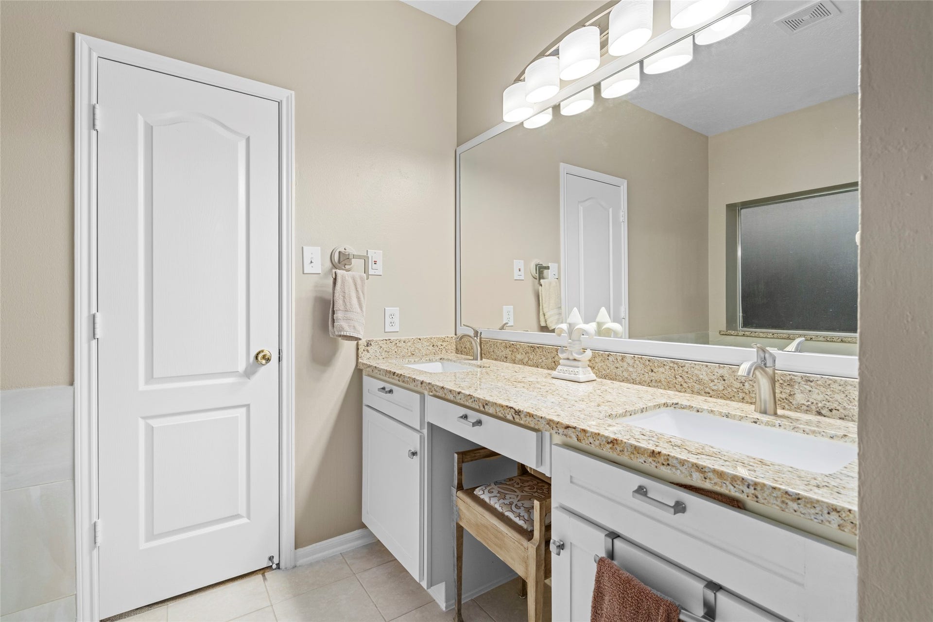 Large dual-sink vanity with generous counter space and storage creates a practical setup for everyday routines. The spacious vanity area complements the home's larger primary suite and provides the functionality buyers often prioritize in a primary bath.