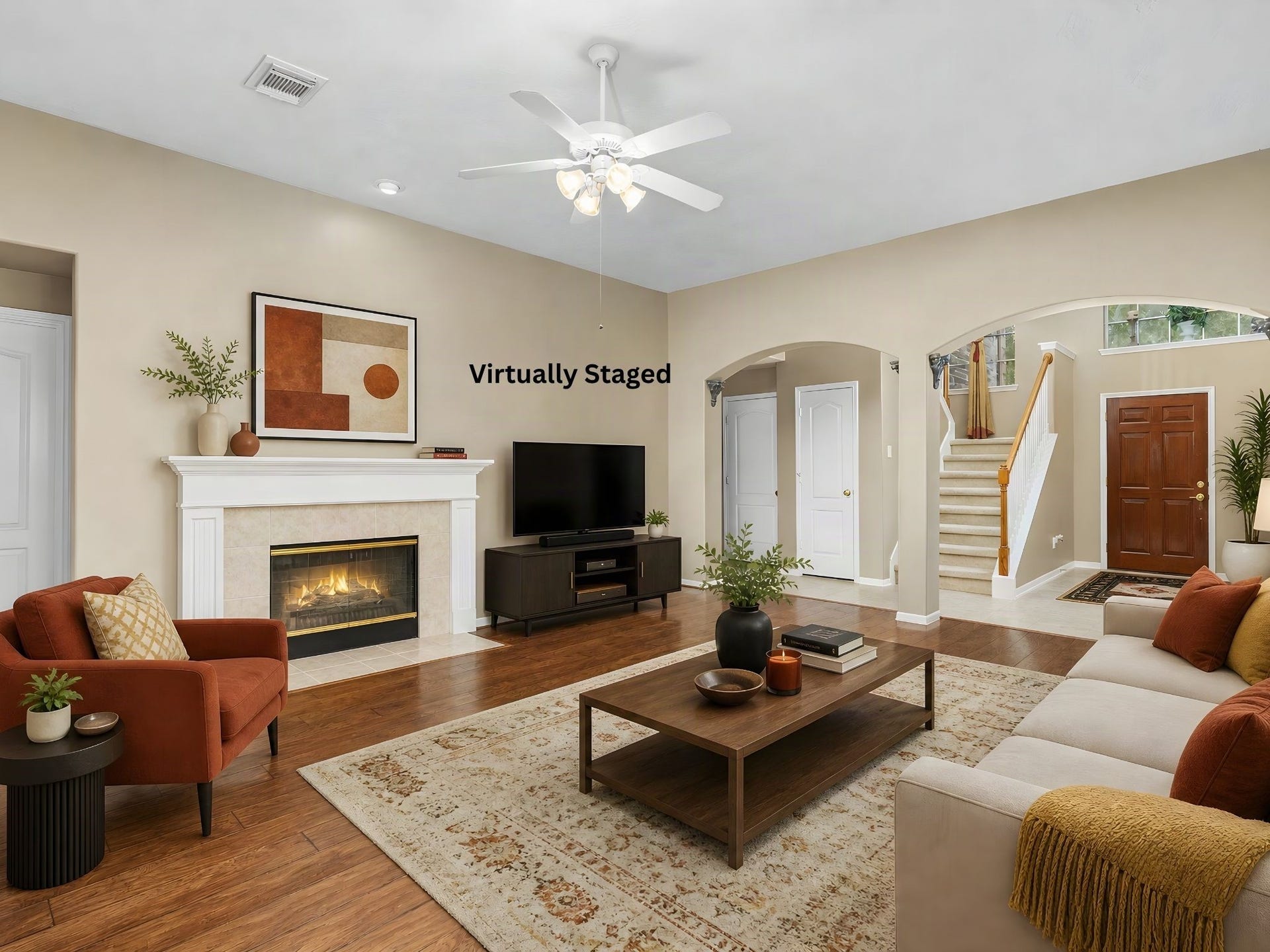 Virtually staged living room showcases the potential of the fireplace and surrounding space as a comfortable focal point for gatherings and relaxation. The architectural openings and connection to the entry and staircase reinforce the home's open, welcoming character. Virtual staging illustrates potential use and design; furnishings are not included.