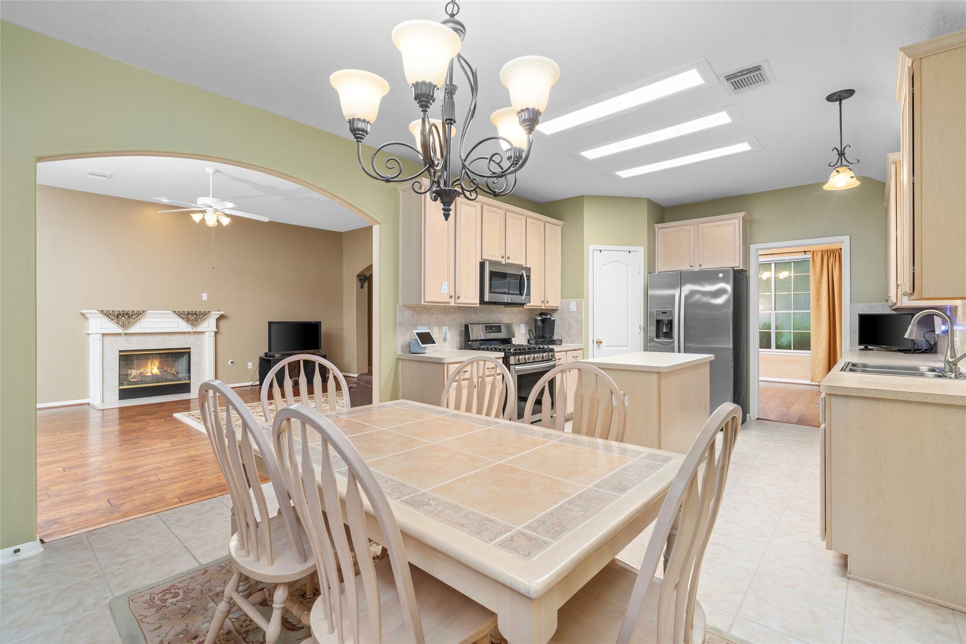 The kitchen opens toward the living area and fireplace, creating a practical layout for entertaining and keeping everyone connected. This is a strong feature for buyers who want a home where cooking, conversation, and everyday family life can happen in the same shared space.