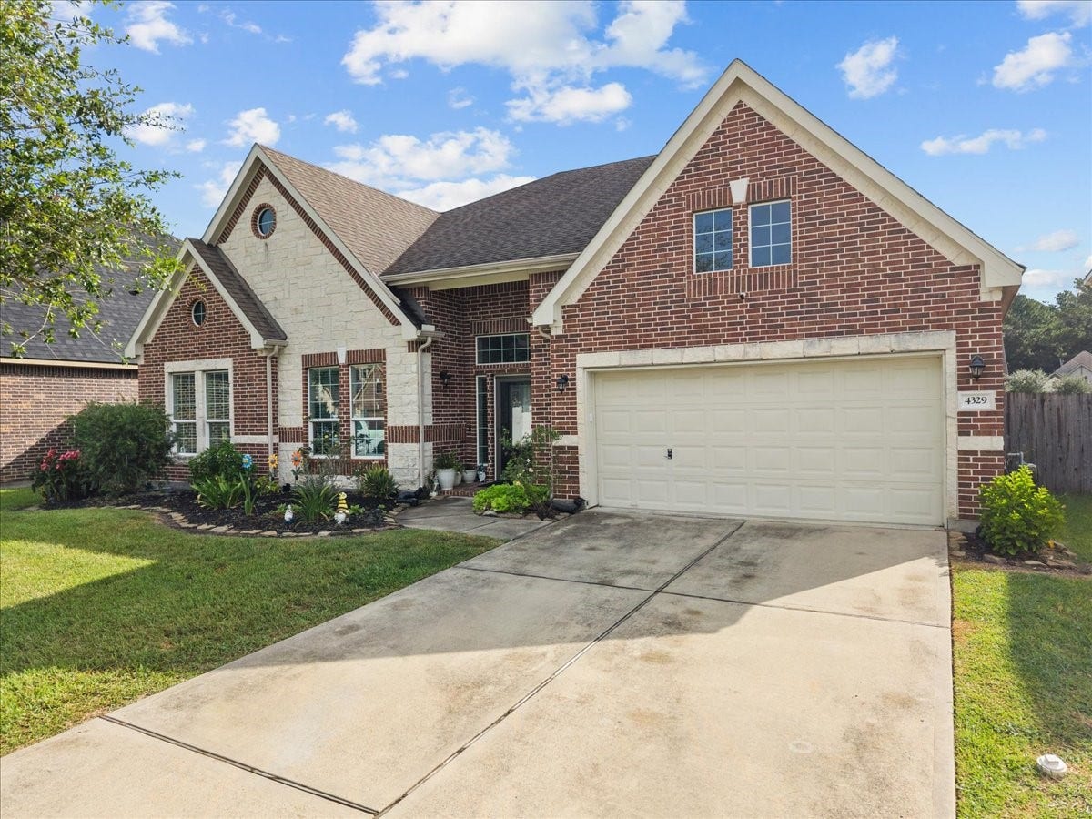4329 S Meridian Greens Drive, Dickinson, TX 77539 Classic brick and stone curb appeal with an attached 3 car garage and wide driveway.