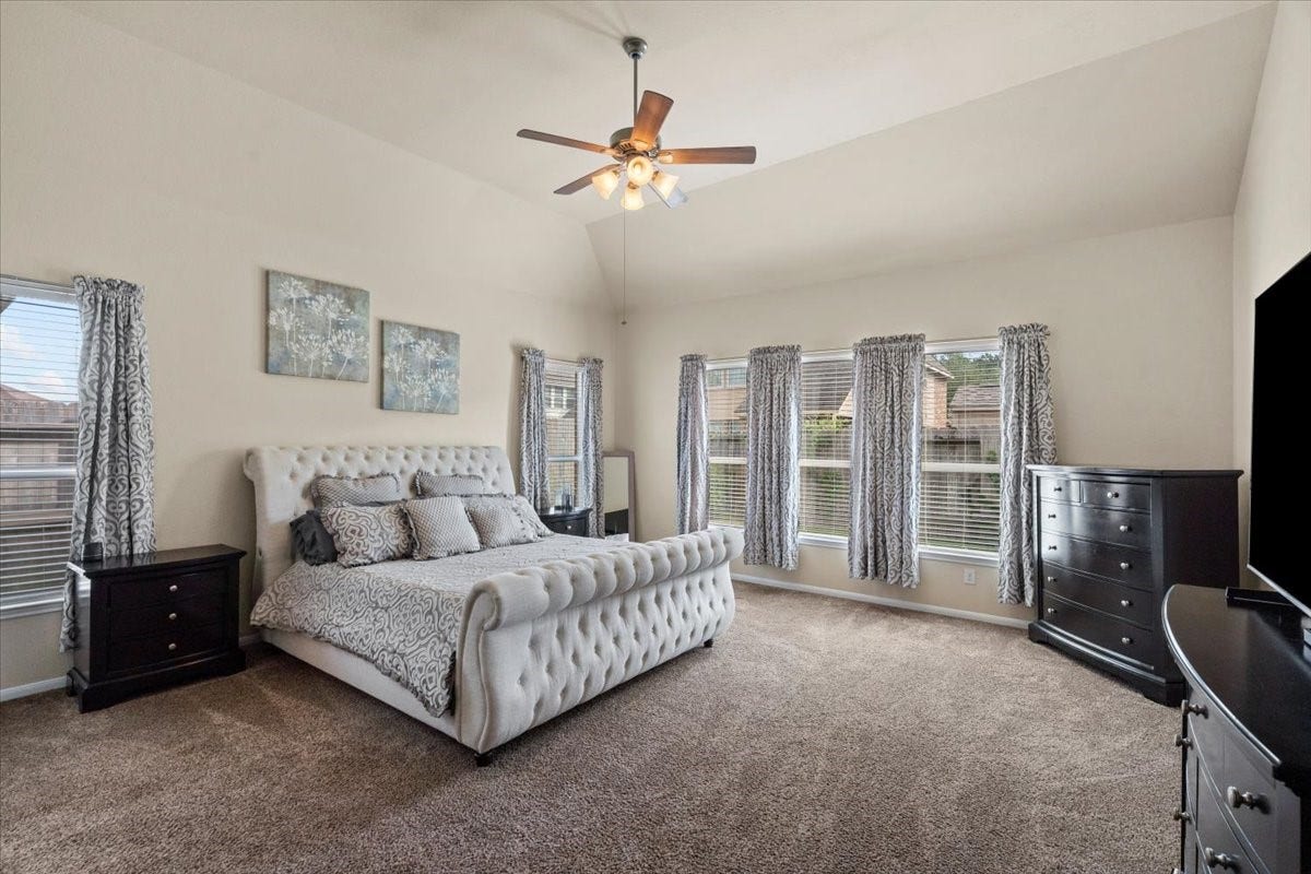 4329 S Meridian Greens Drive, Dickinson, TX 77539 Primary bedroom with room for a sitting area and large windows.