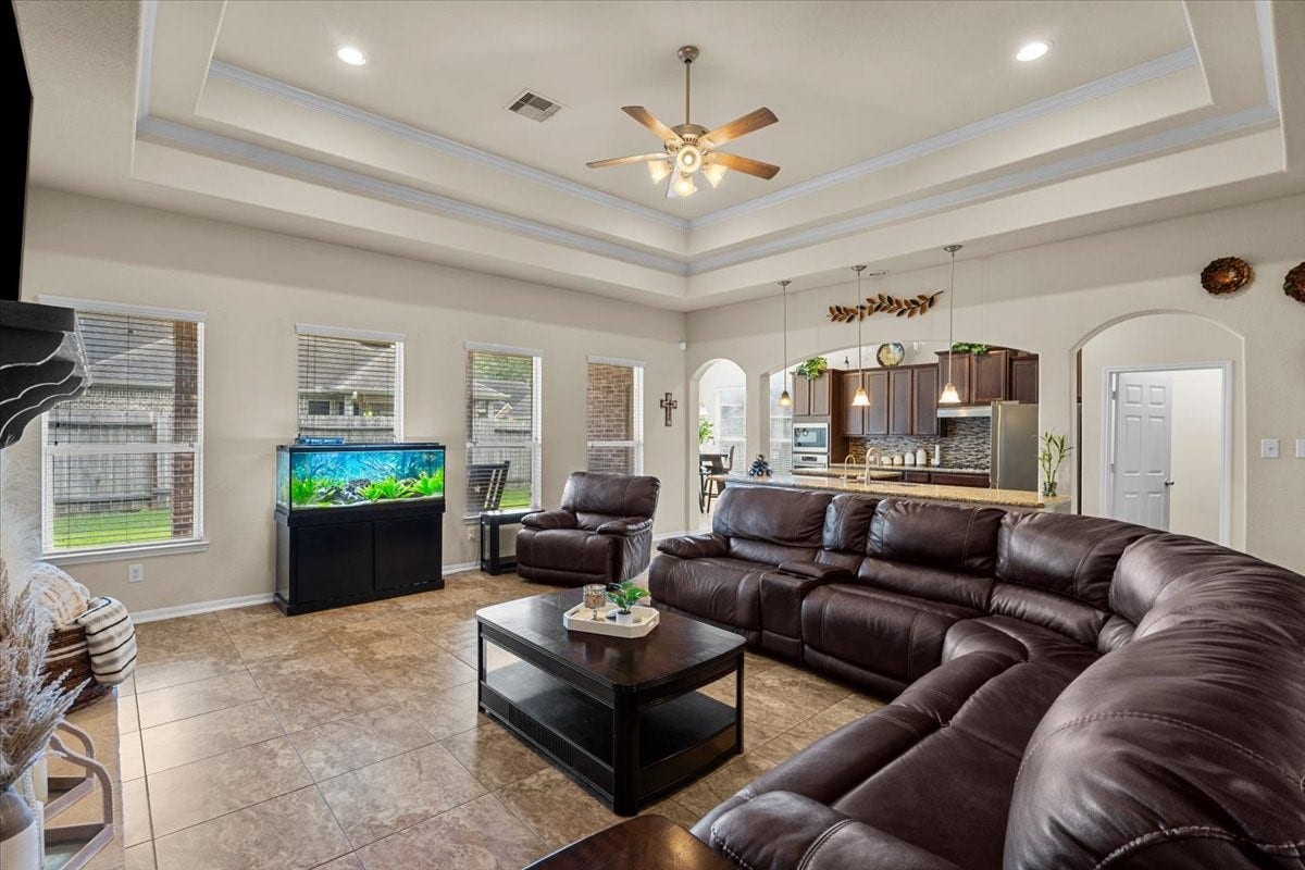 4329 S Meridian Greens Drive, Dickinson, TX 77539 Family room view toward the kitchen, showing off the open-concept layout.