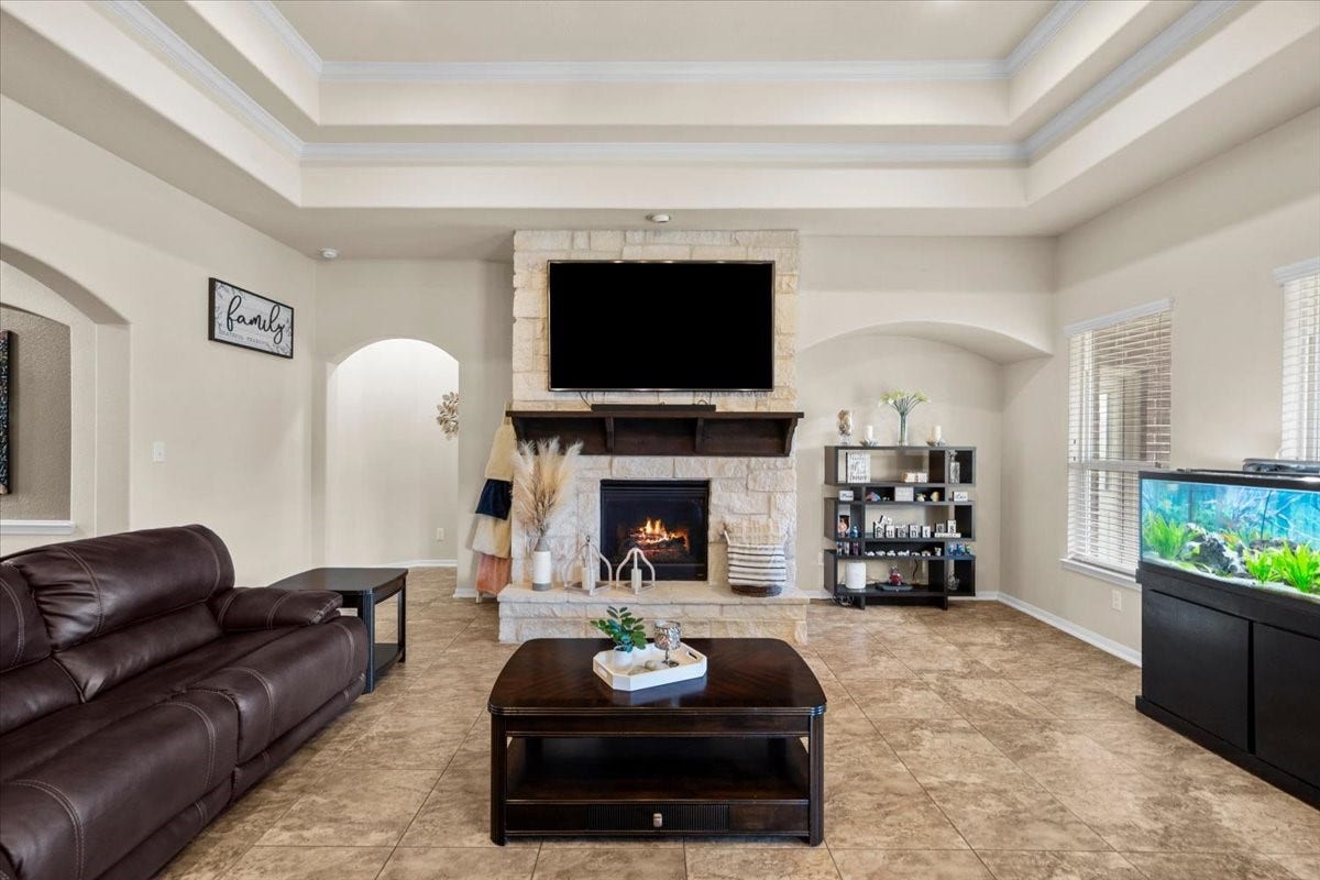 4329 S Meridian Greens Drive, Dickinson, TX 77539 Family room centered around the fireplace with beautiful tray ceiling detail.