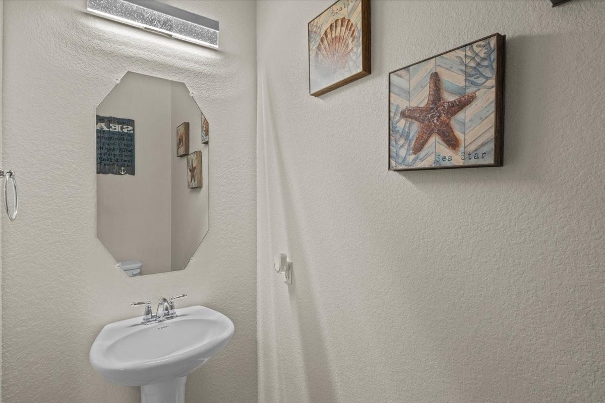 4329 S Meridian Greens Drive, Dickinson, TX 77539 Guest bath with pedestal sink.