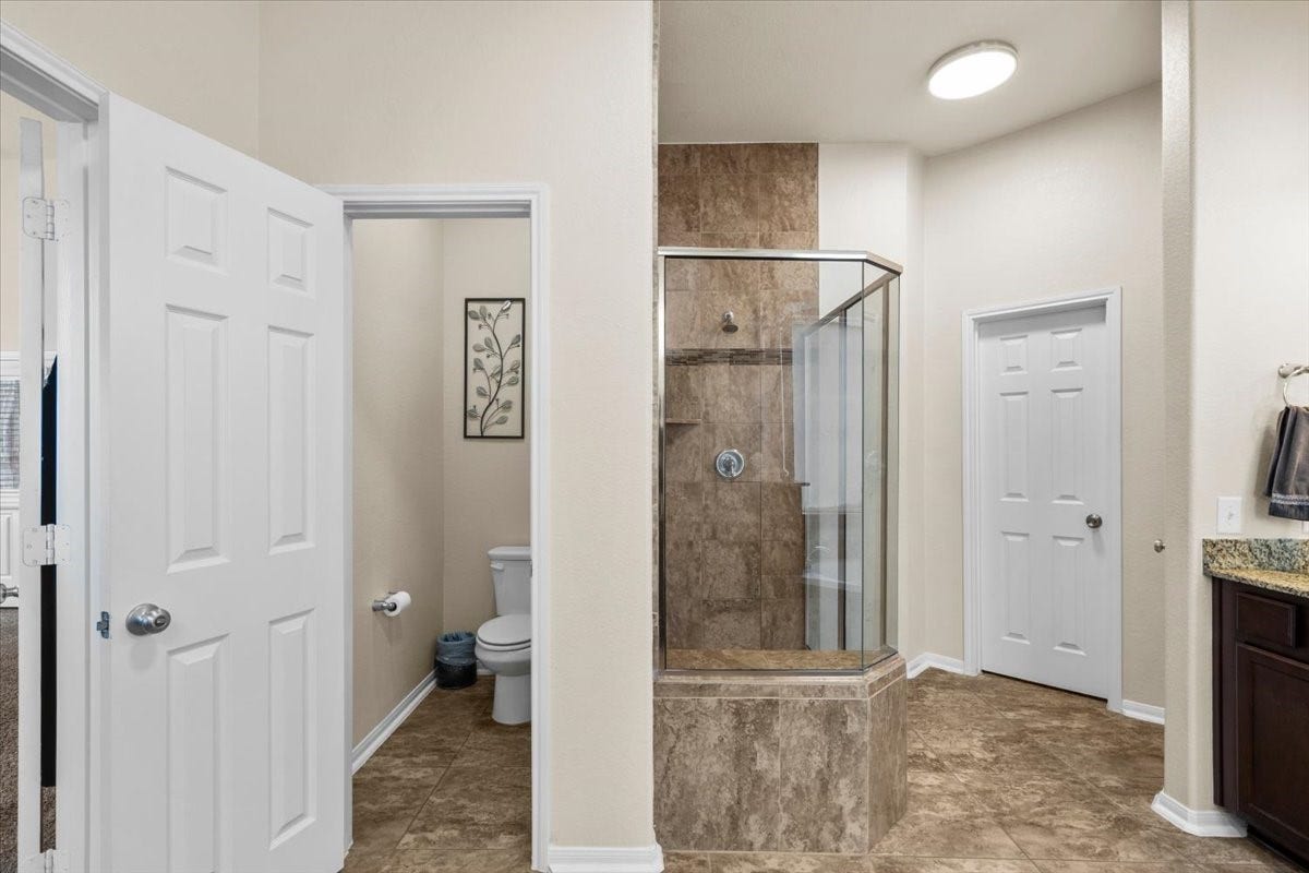 4329 S Meridian Greens Drive, Dickinson, TX 77539 Separate glass-enclosed shower in the primary bath.