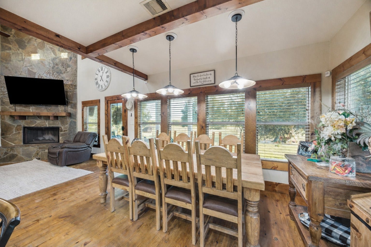 A large butcher-block island anchors this kitchen, offering abundant prep space and bar-style seating. Surrounded by stainless steel appliances, stone backsplash, and natural wood details, the kitchen is both timeless and totally functional. Virtually decluttered to help visualize potential use.