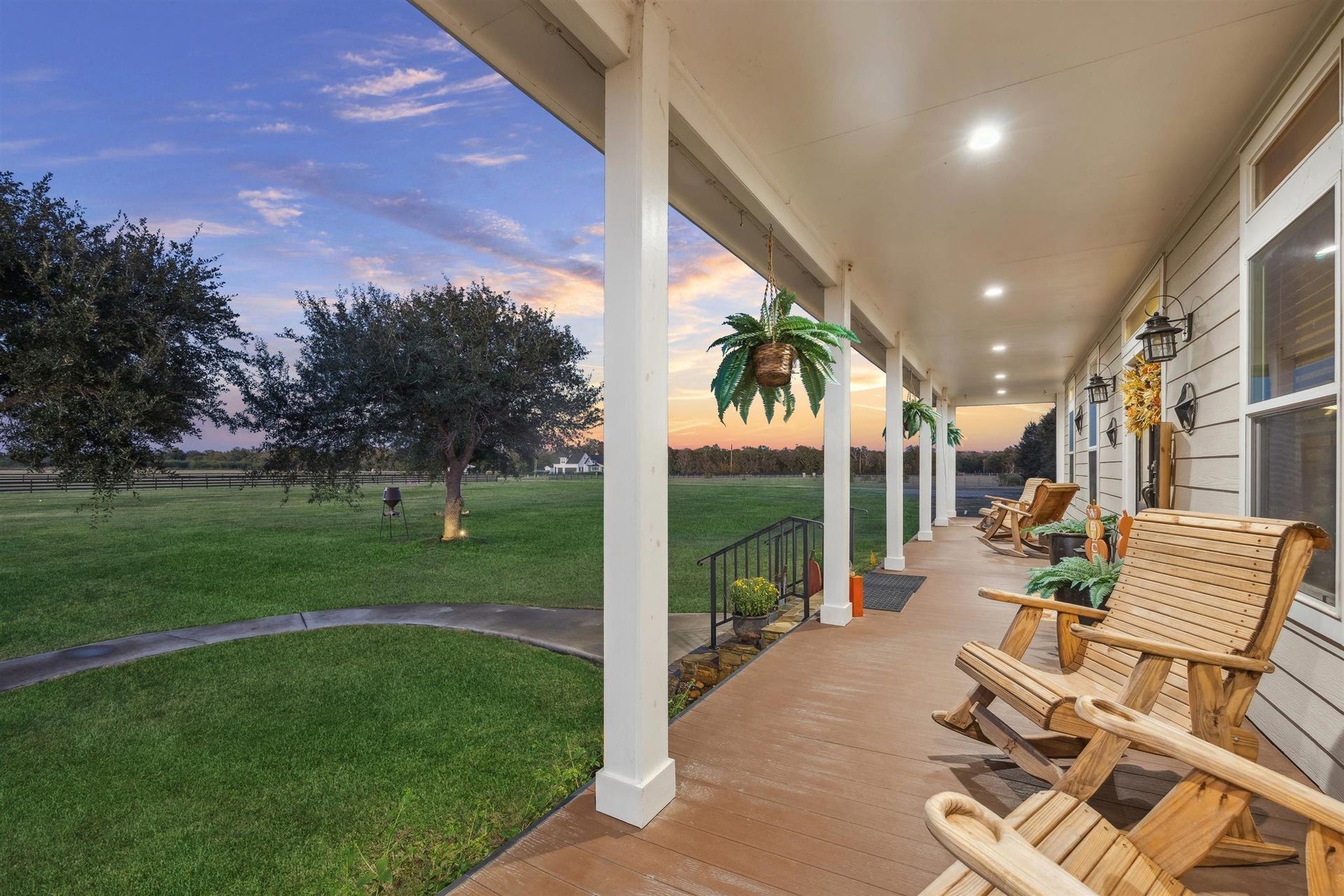 Stretching across the side of the home, this expansive covered porch delivers country luxury at its finest. Ideal for sipping coffee or hosting under the stars, this space wraps you in 180-degree views of rolling green landscape and oak-dotted fields part of a property that qualifies for a wildlife exemption, combining beauty with practical tax benefits.