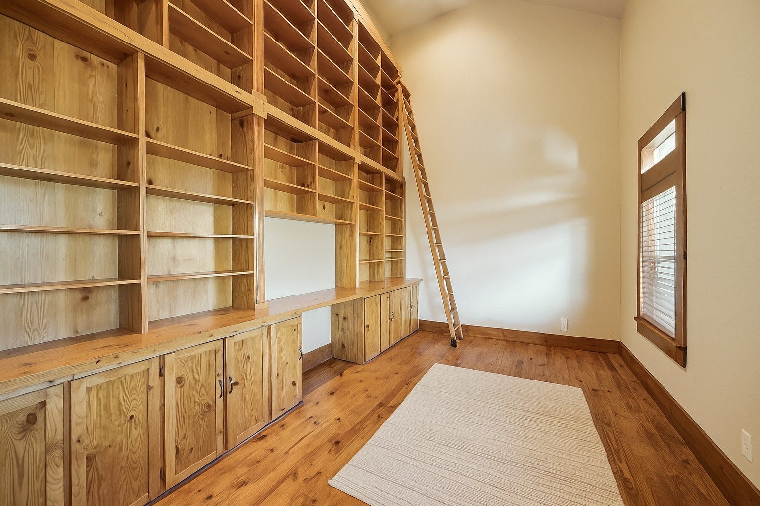A towering wall of custom built-ins, rolling library ladder, and spacious desk area make this home office a book-lovers dream. Perfect as a learning space, creative studio, or productive work-from-home retreatcozy, charming, and completely functional. Virtually decluttered to help visualize potential use.