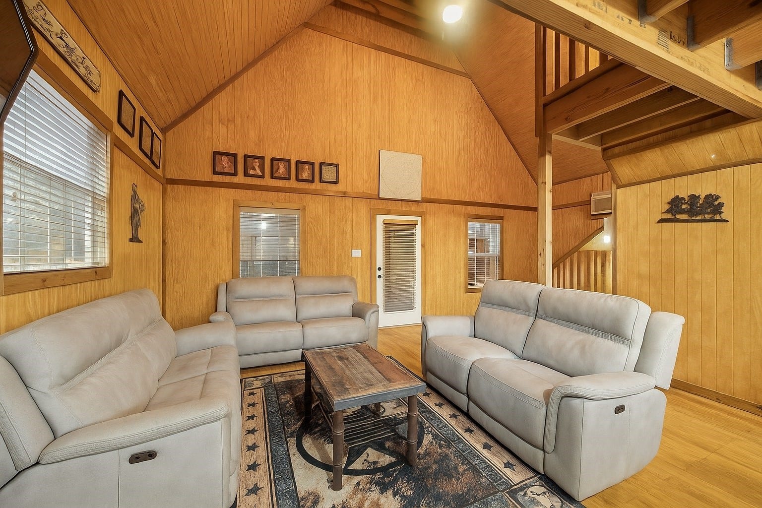 Rustic textures and country comfort define this living space. With room to gather, relax, and unwind, its ideal for entertaining or peaceful mornings with coffee in hand. Wood tones and western flair set the tone for this private retreat. Virtually decluttered to help visualize potential use.