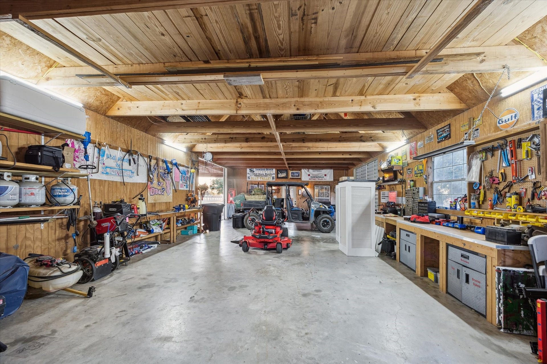 This expansive workshop is a hobbyists dream, complete with concrete floors, ample lighting, and built-in workstations. Whether youre wrenching on a side-by-side or crafting your next project, this space is ready for action.
