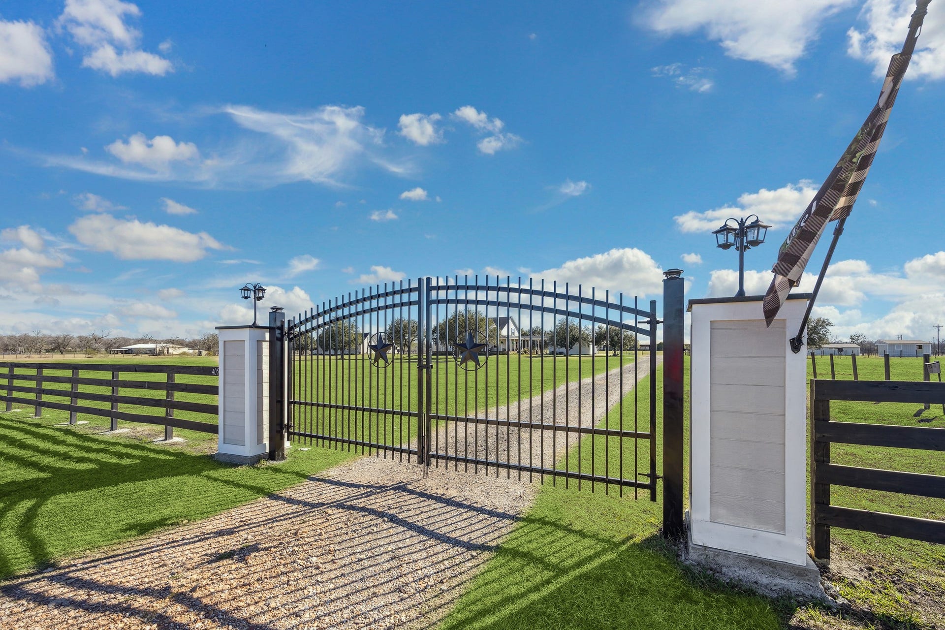 This secure, star-accented gate provides both safety and statement for the property. Framing expansive green pastureland, it offers a picturesque first impression while marking the beginning of your serene ranch lifestyle. Ideal for horse owners, this entry adds peace of mind and pride of arrival every time you come home to your personal sanctuary.