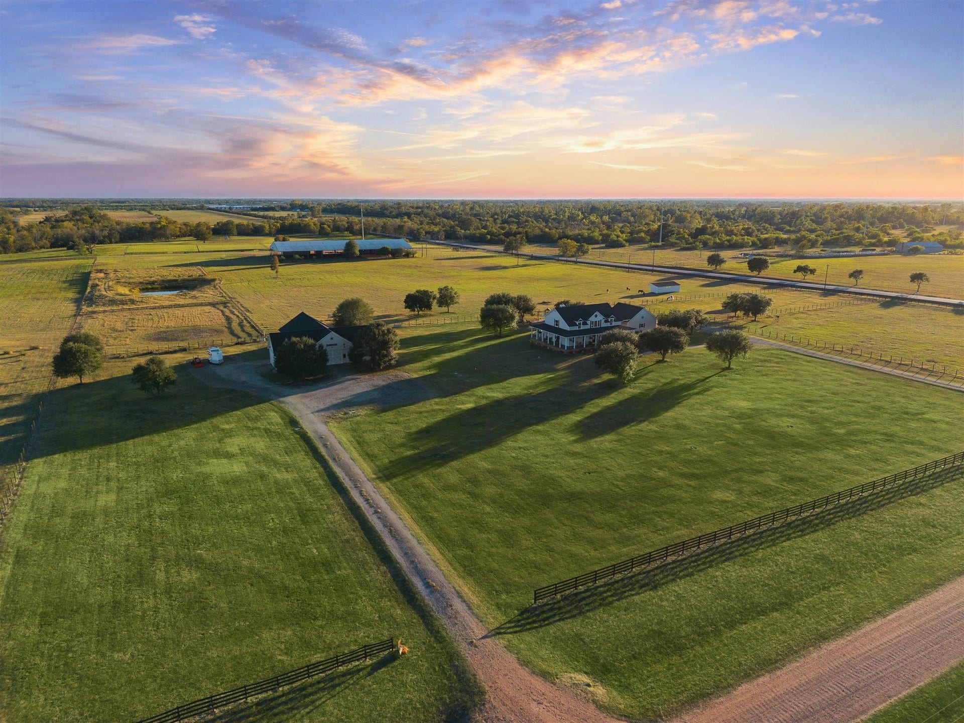Breathtaking Aerial view of this nearly 19-acre, wildlife-exempt estate complete with manicured lawns, fencing, multiple outbuildings, and wide-open pastures perfect for horses or livestock. The picturesque farmhouse and barns are surrounded by the beauty of open skies, peaceful countryside, and land that qualifies for a wildlife exemption offering both scenic value and tax savings.