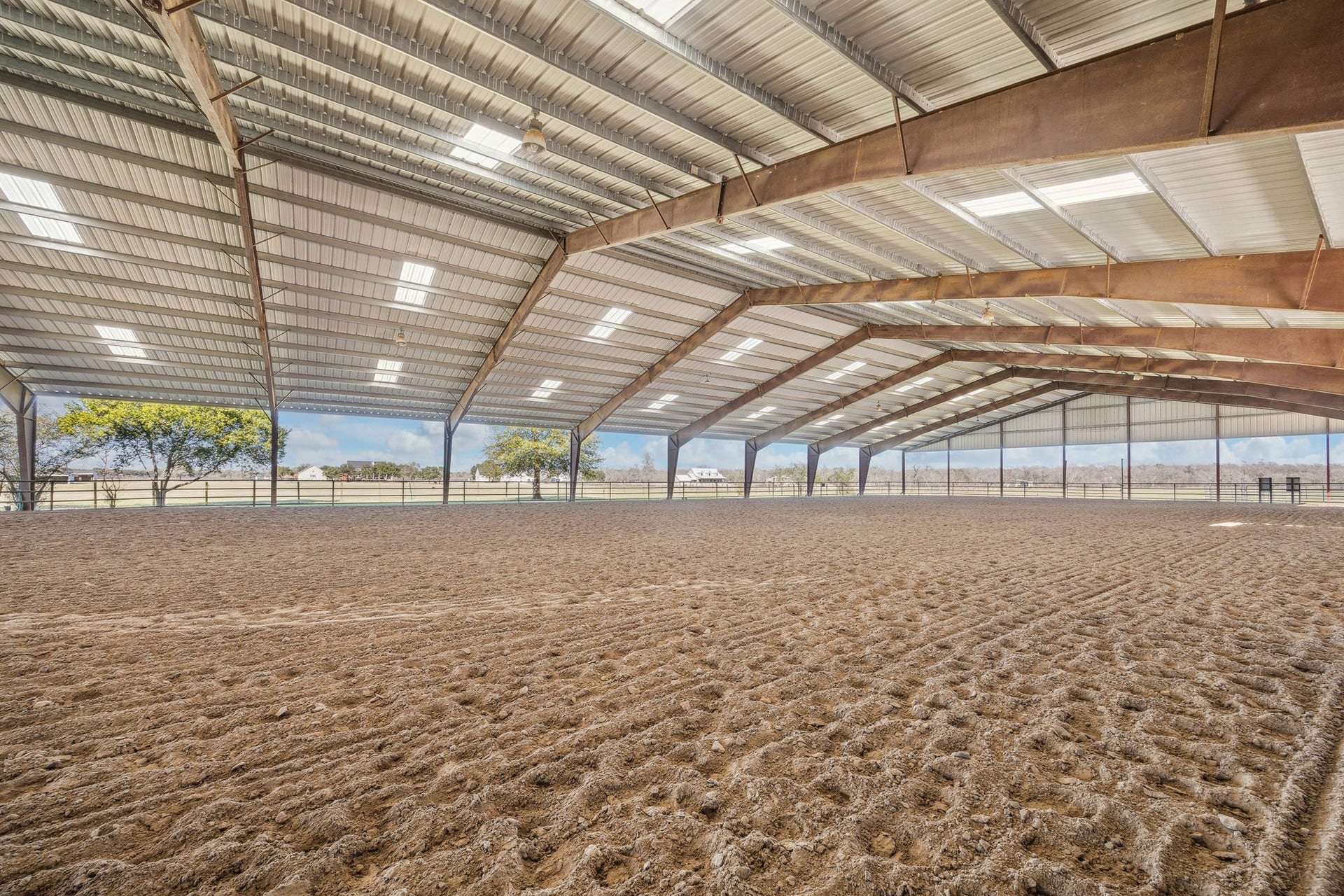 Enjoy the rare luxury of the community covered arena perfect for training, turnout, or all-weather riding. With ample lighting and space to work your horses year-round, this private structure is a dream setup for professionals and passionate equestrians alike.