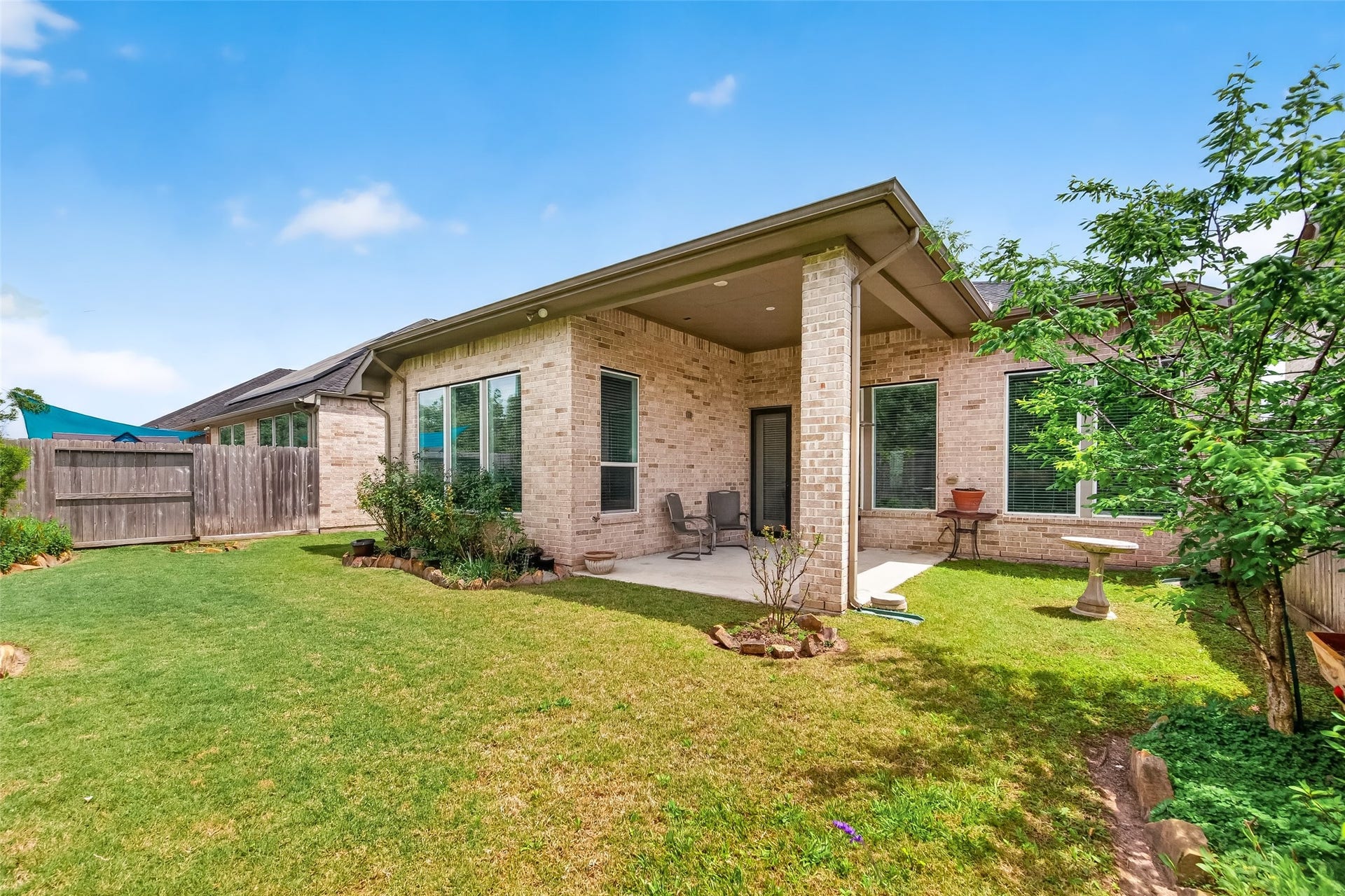 3415 Mckinney Ridge Drive, Houston, TX 77059 Covered patio area accented by gardens with easy to maintain native plants.