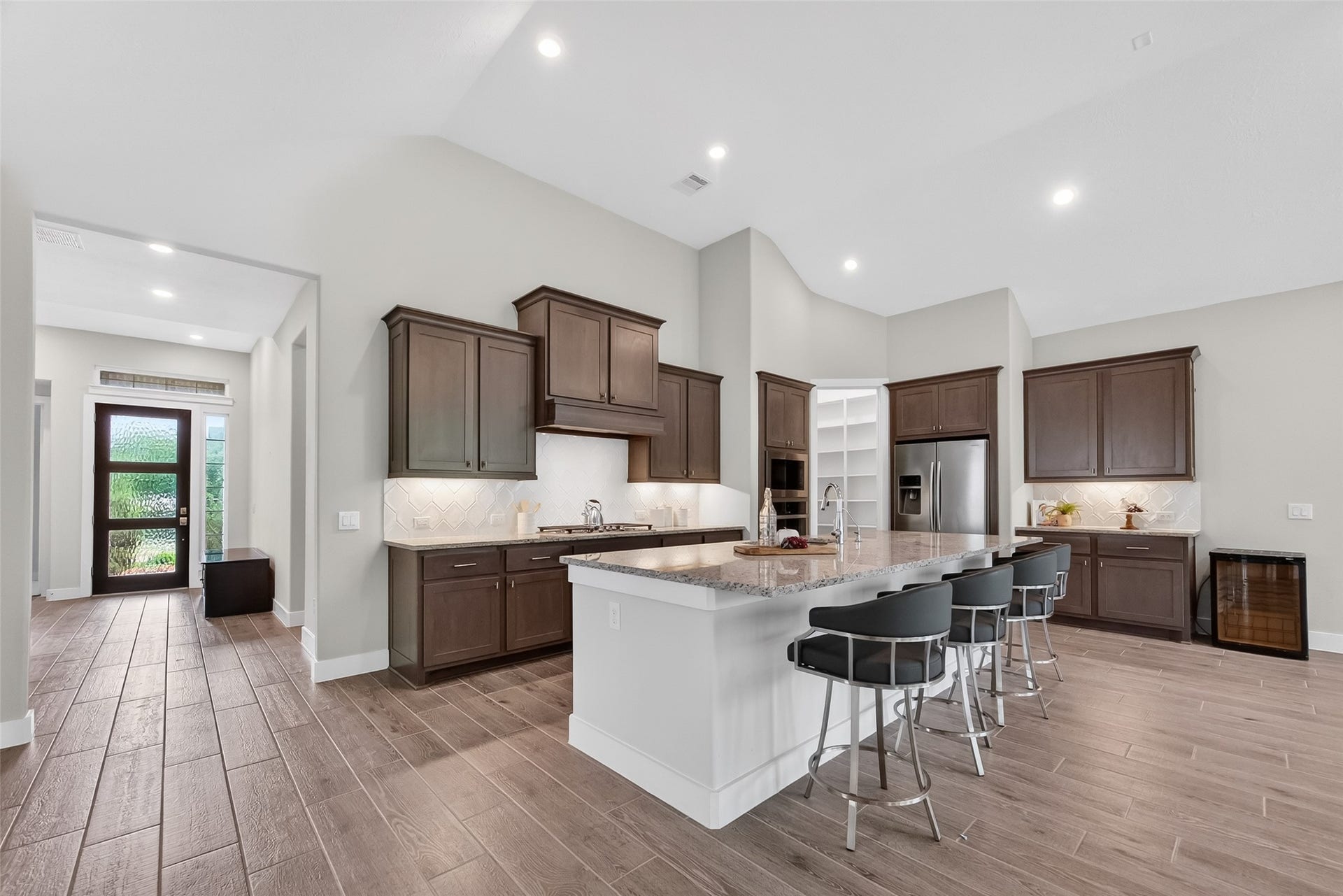 3415 Mckinney Ridge Drive, Houston, TX 77059 This beautiful kitchen has modern dark wood cabinets, and an abundance of counter and storage space.