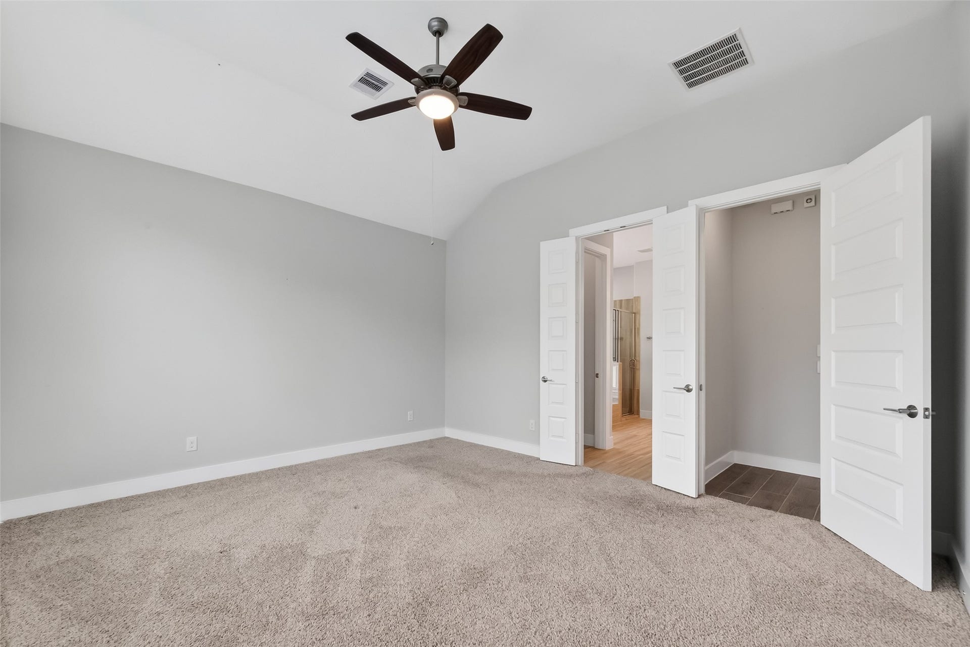 3415 Mckinney Ridge Drive, Houston, TX 77059 The primary bedroom features a spacious layout. It includes a ceiling fan for comfort and double doors leading to the gorgeous ensuite bath.