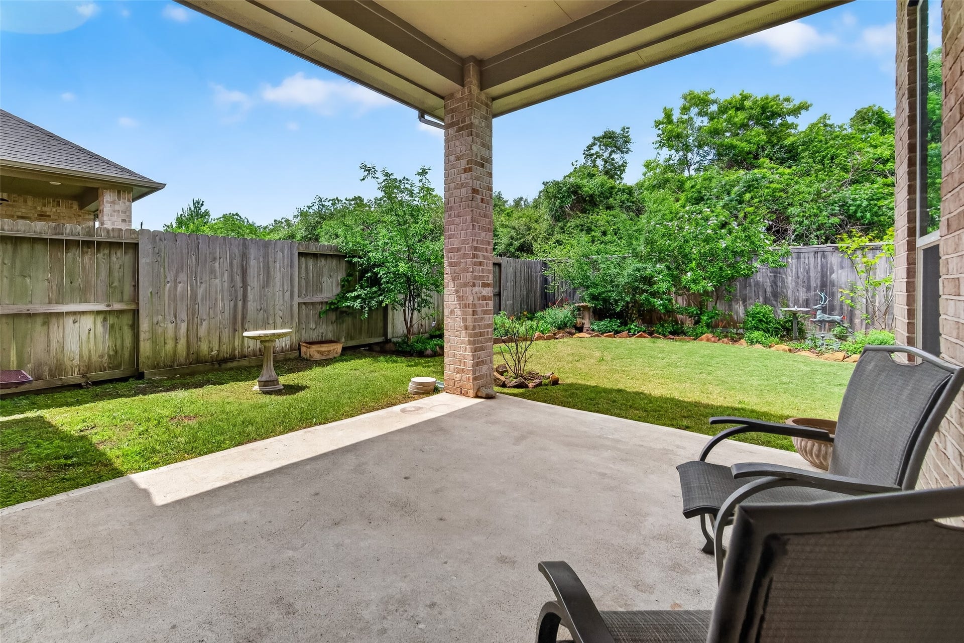3415 Mckinney Ridge Drive, Houston, TX 77059 Great covered backyard patio with two chairs, perfect for watching the birds and relaxation.
