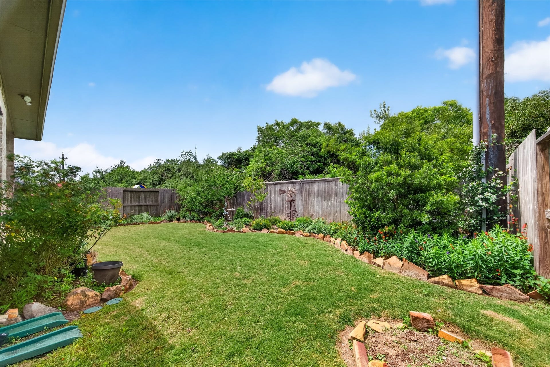 3415 Mckinney Ridge Drive, Houston, TX 77059 The outdoor space is accented with a rock-lined garden bed, offering a private and serene outdoor area.