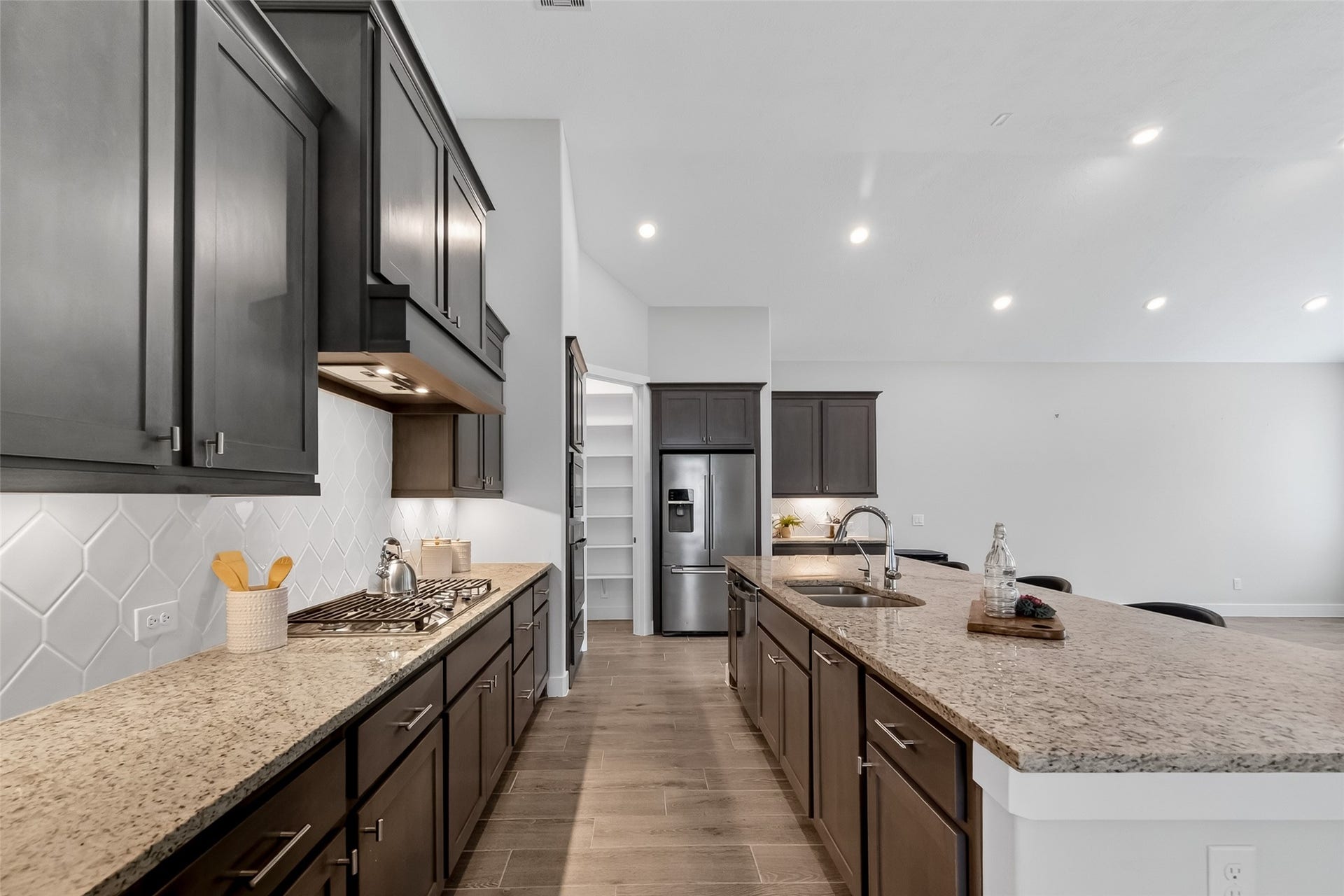3415 Mckinney Ridge Drive, Houston, TX 77059 Stainless steel appliances, including the refrigerator, complement the sleek design. Recessed lighting and an open layout create a bright and inviting space.