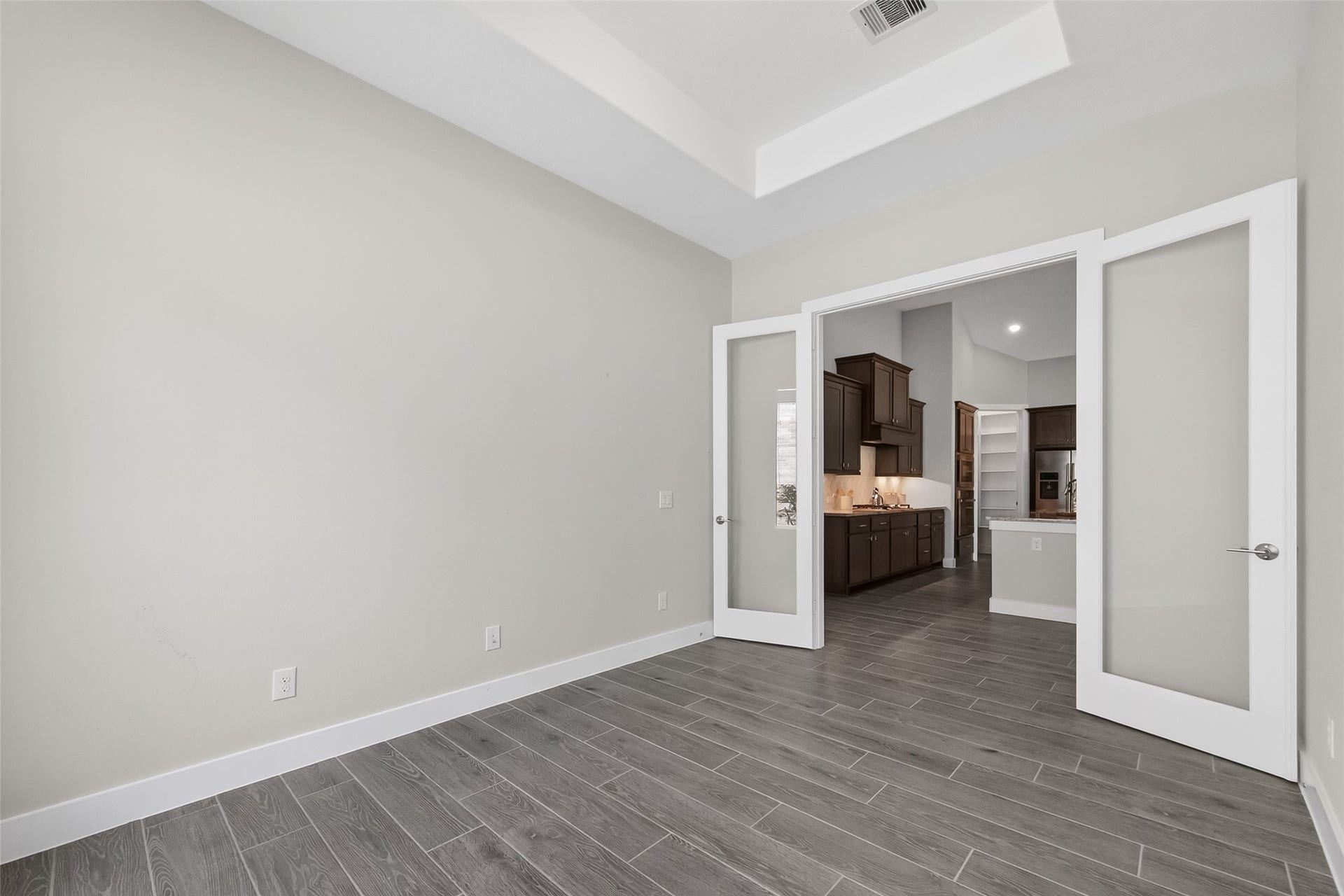 3415 Mckinney Ridge Drive, Houston, TX 77059 Double glass doors and tray ceiling enhance this spacious room.