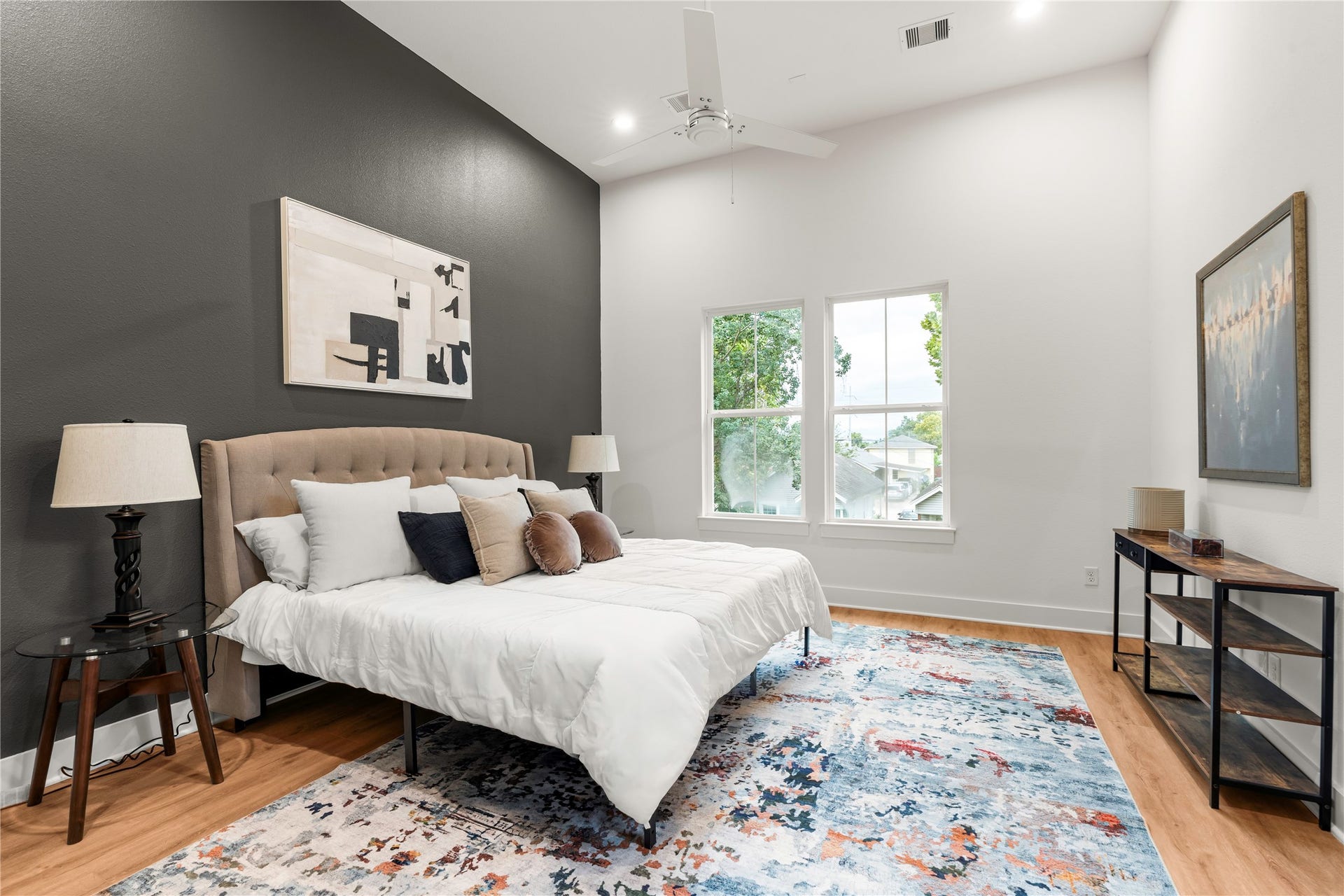 6619 Avenue Q, #A/B, Houston, TX 77011 Peaceful primary bedroom retreat featuring high ceilings and dark accent design wall.