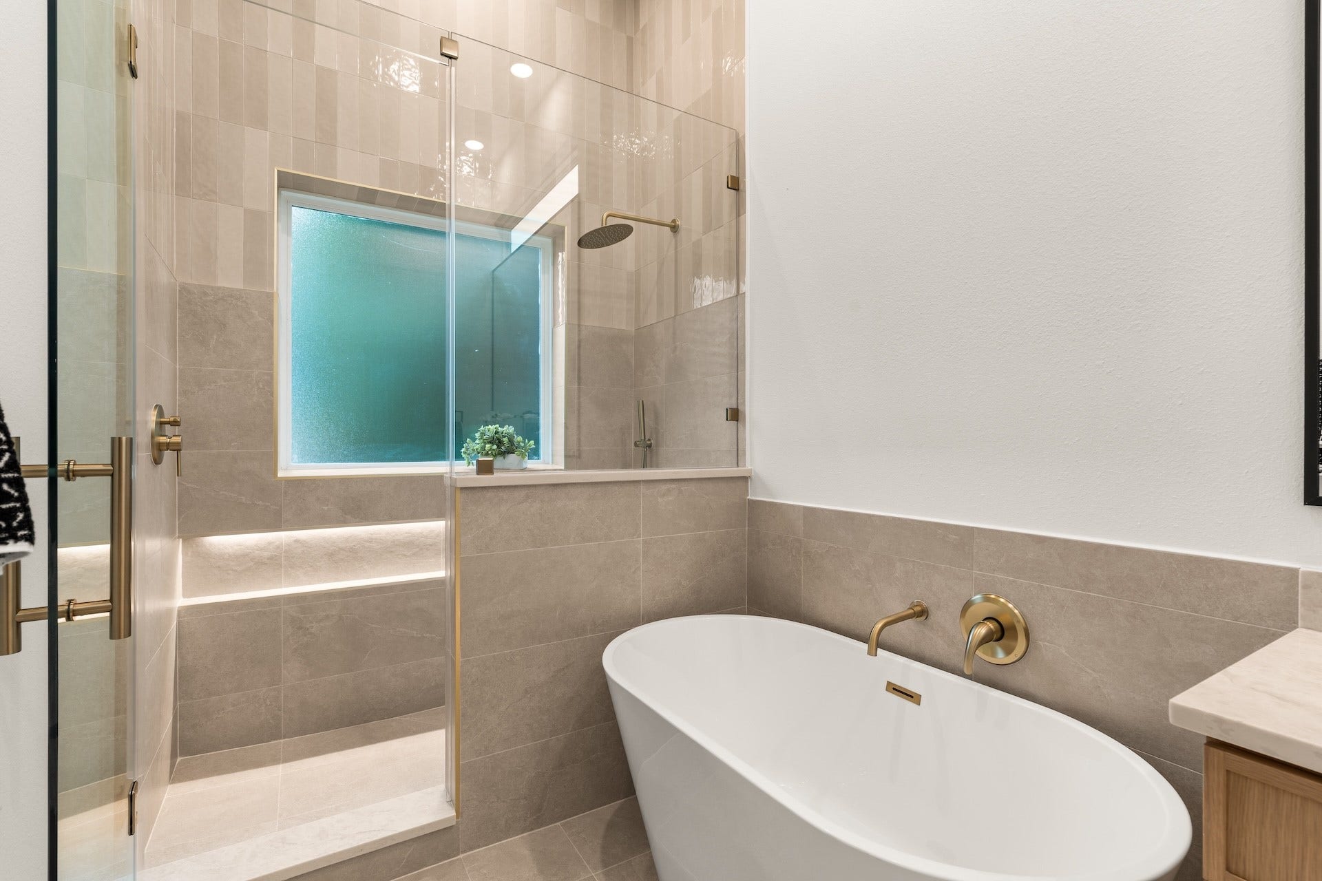 6619 Avenue Q, #A/B, Houston, TX 77011 Deluxe soaking tub paired with an adjacent glass walk-in shower for a daily spa experience.