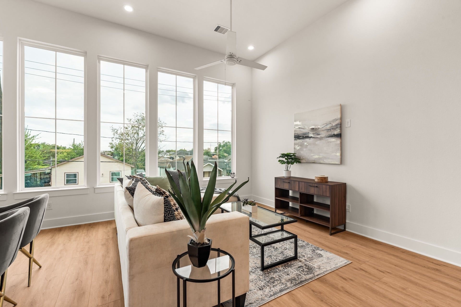 6619 Avenue Q, #A/B, Houston, TX 77011 Expansive second-story living space anchored by warm wood-look flooring and soaring ceiling height.