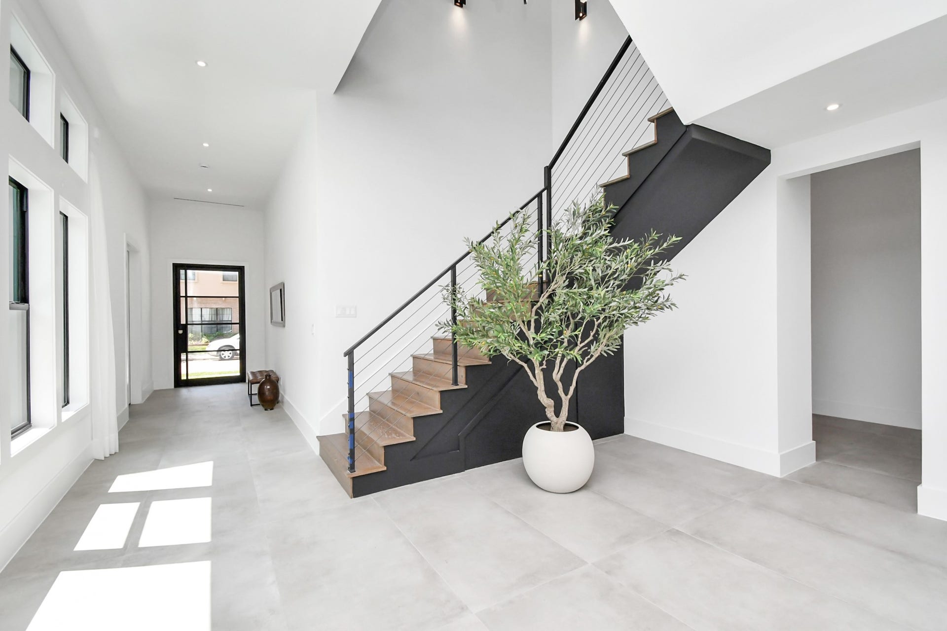 5414 John Dreaper Drive, Houston, TX 77056 Stairs feature premium wood flooring with iron stair railing.