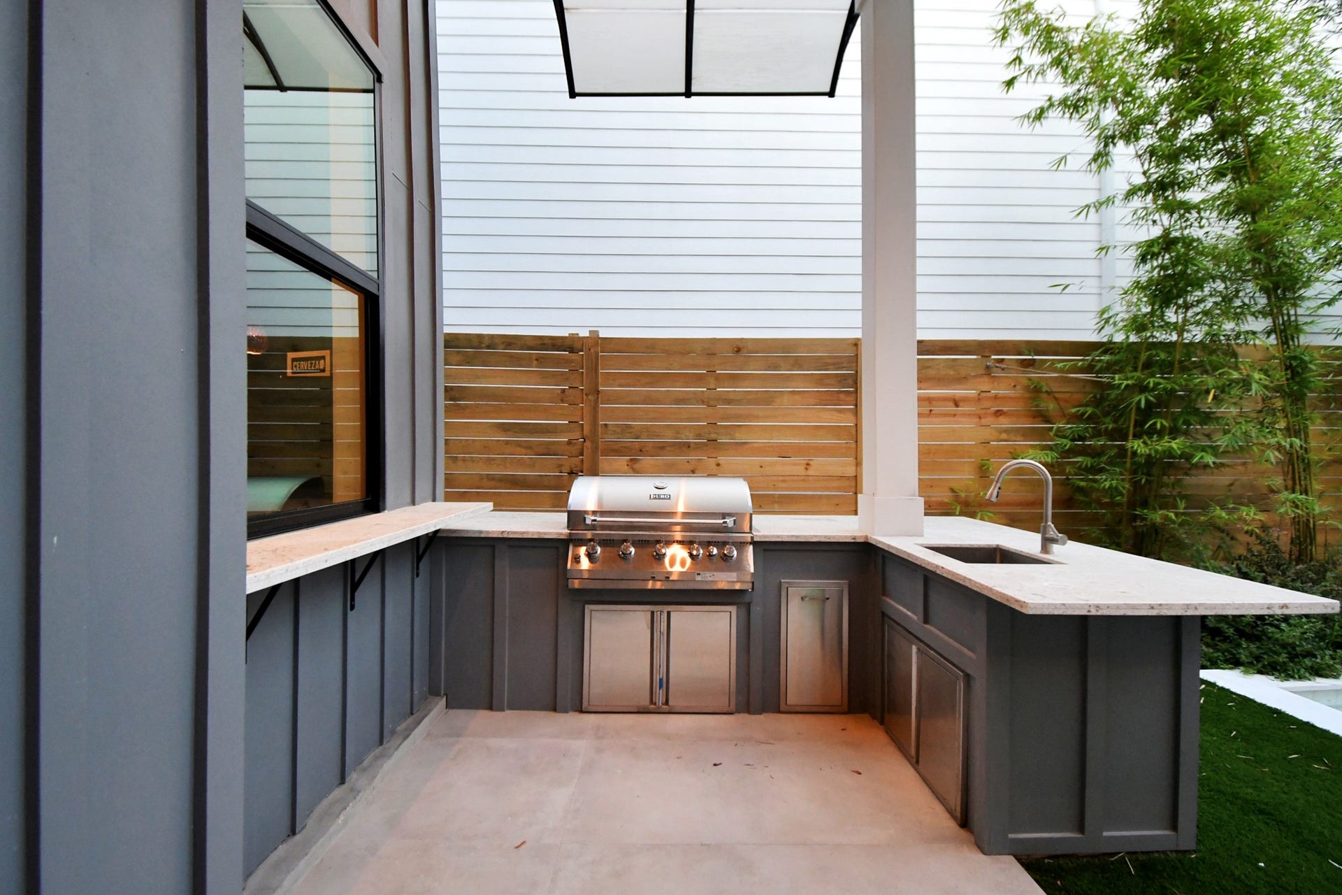 5414 John Dreaper Drive, Houston, TX 77056 Outdoor kitchen with gas grill and sink.