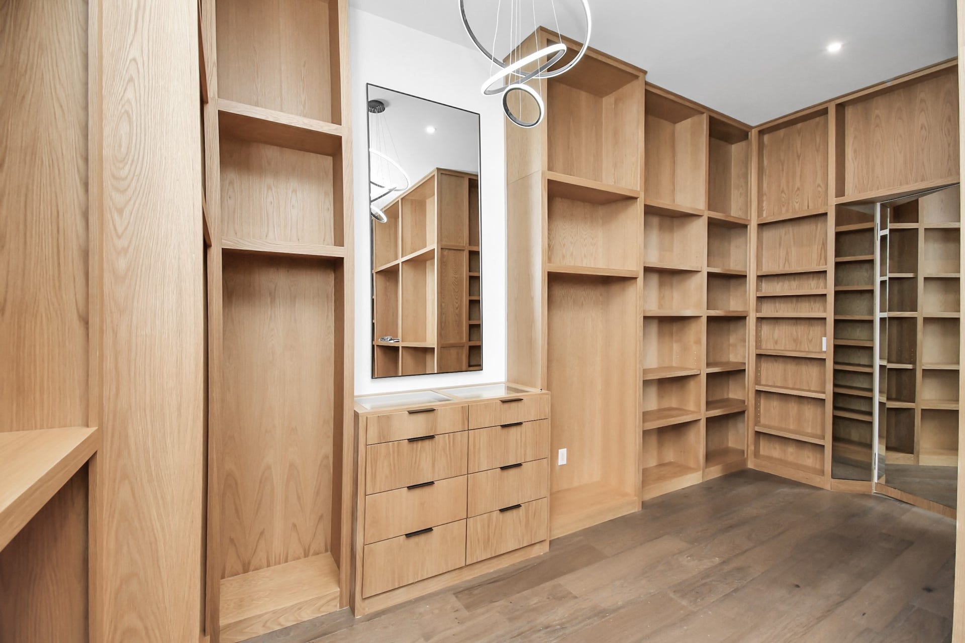 5414 John Dreaper Drive, Houston, TX 77056 Primary walk in closet with custom cabinetry and ample storage.