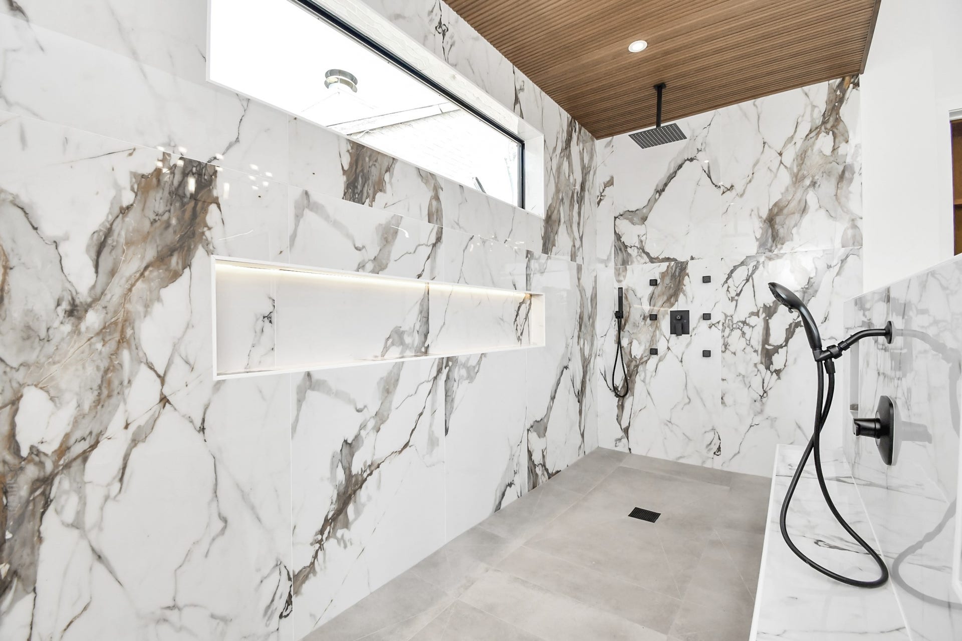 5414 John Dreaper Drive, Houston, TX 77056 Massive shower with dual shower heads and a sitting area with built in shower head.