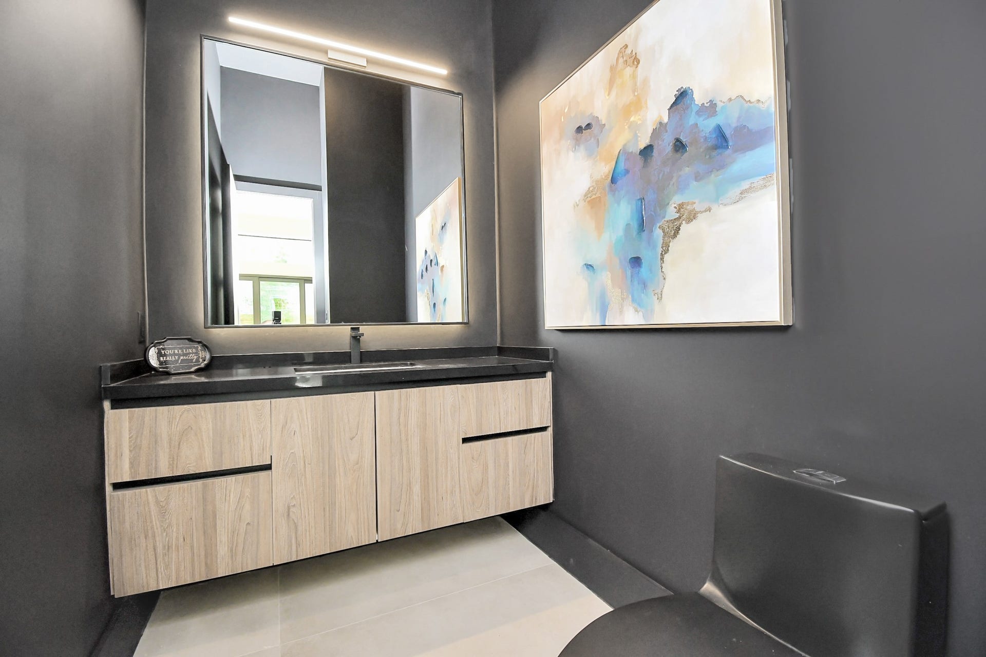 5414 John Dreaper Drive, Houston, TX 77056 Half bathroom with floating shelves and black chic toilette.