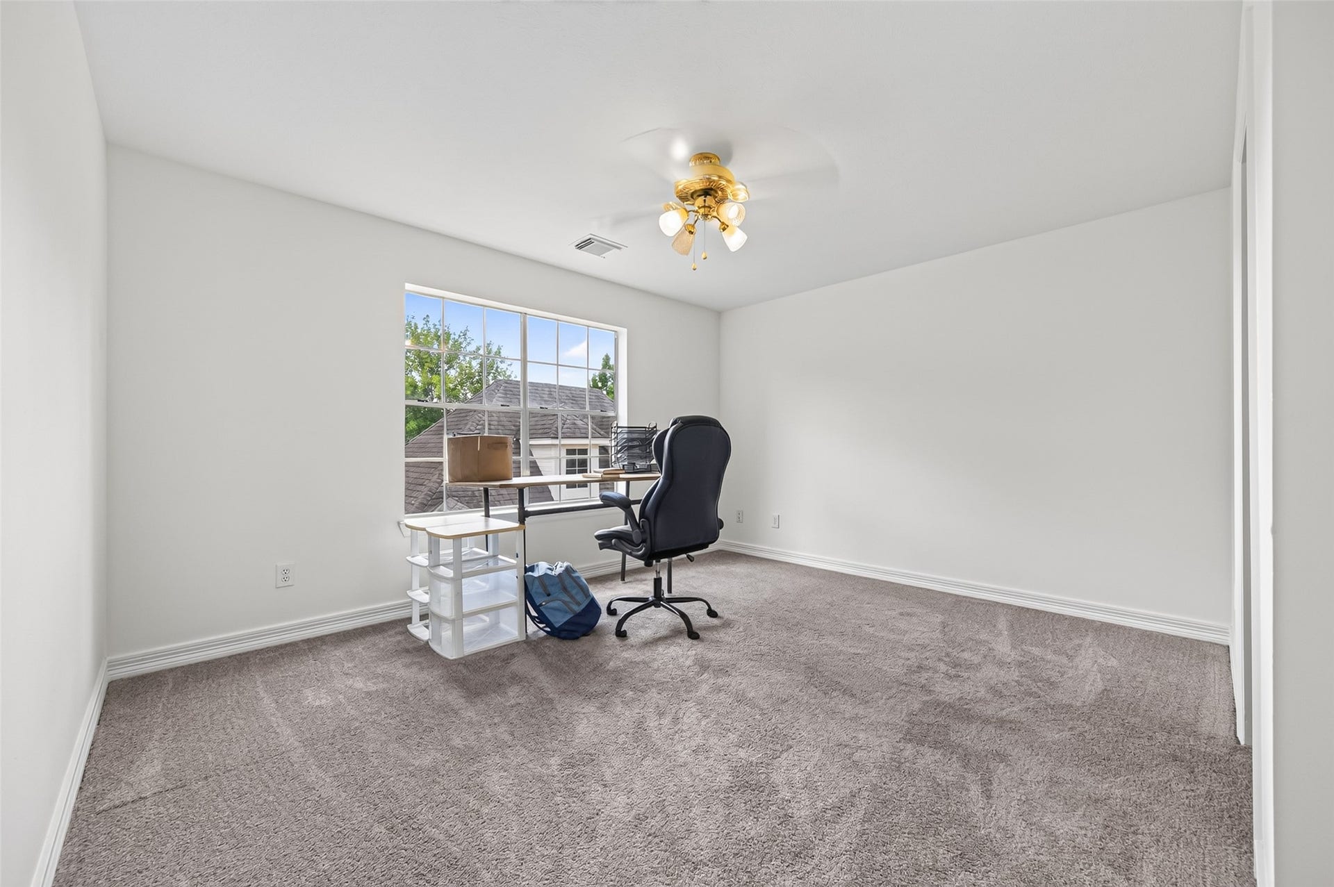 18 Tredington Street, Sugar Land, TX 77479 Bright and spacious room with carpeting, featuring a large window that invites natural light.