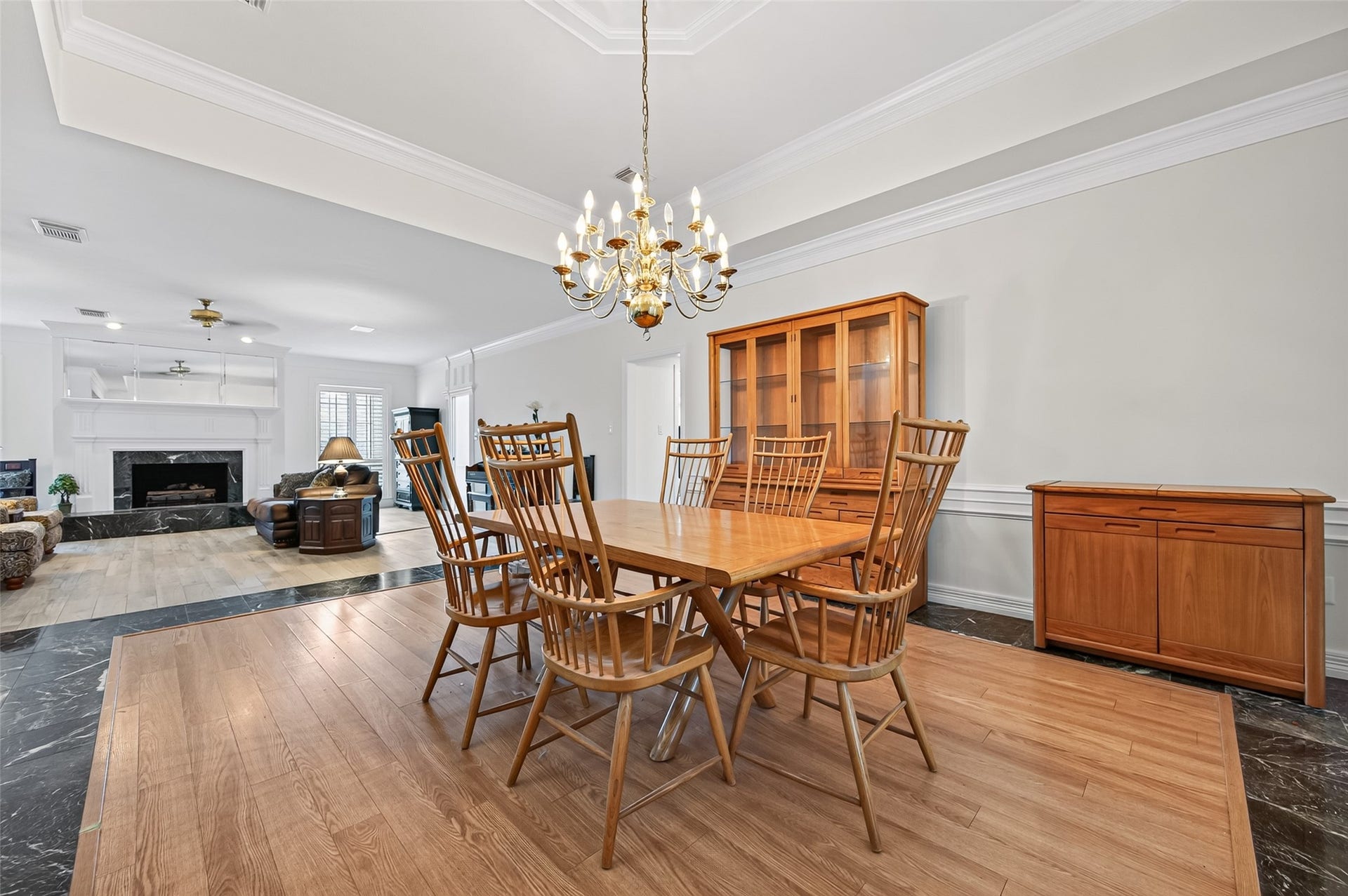 18 Tredington Street, Sugar Land, TX 77479 Elegant dining. The open layout flows seamlessly into a cozy living space featuring a stylish fireplace.