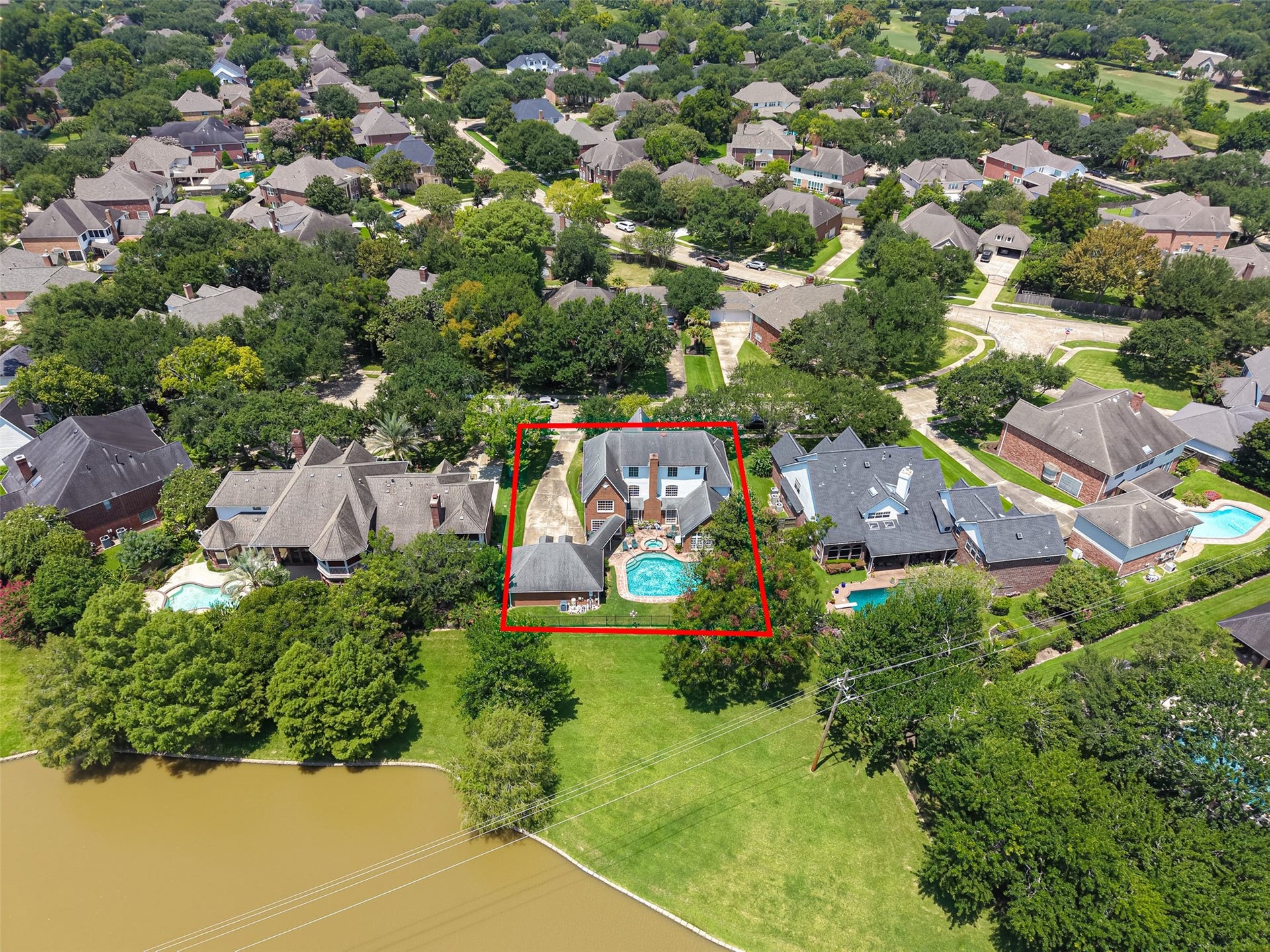 18 Tredington Street, Sugar Land, TX 77479 Nestled in a lush, tree-lined neighborhood, this elegant home boasts a spacious backyard with a refreshing pool, perfect for relaxation and entertaining.