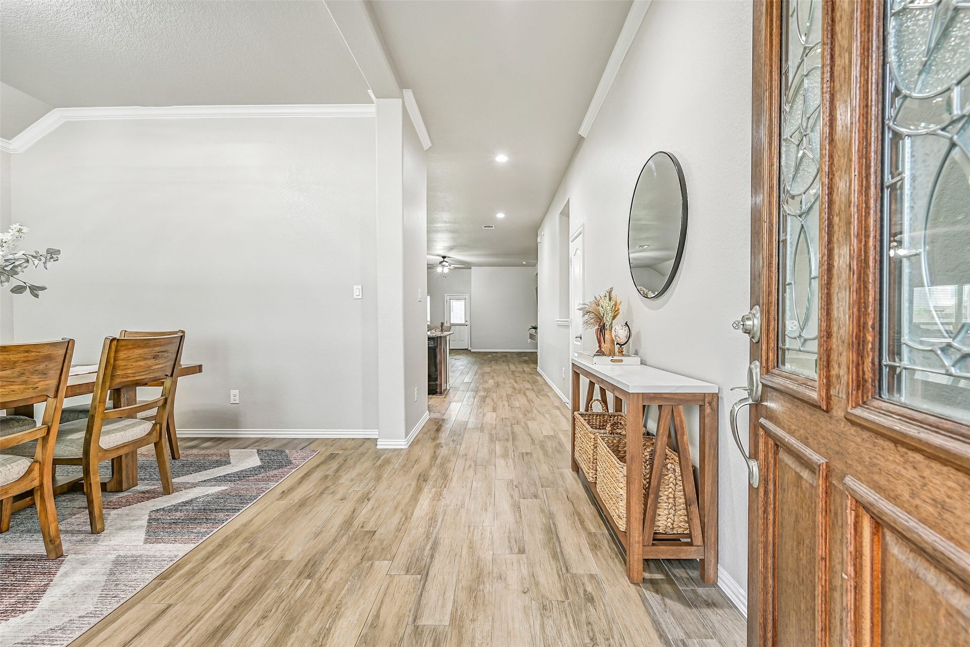 Step inside to discover soaring ceilings, fresh neutral paint, and new wood-look tile flooring that extends throughout the main living areas. The welcoming foyer provides a seamless introduction to the home's bright, open-concept design.