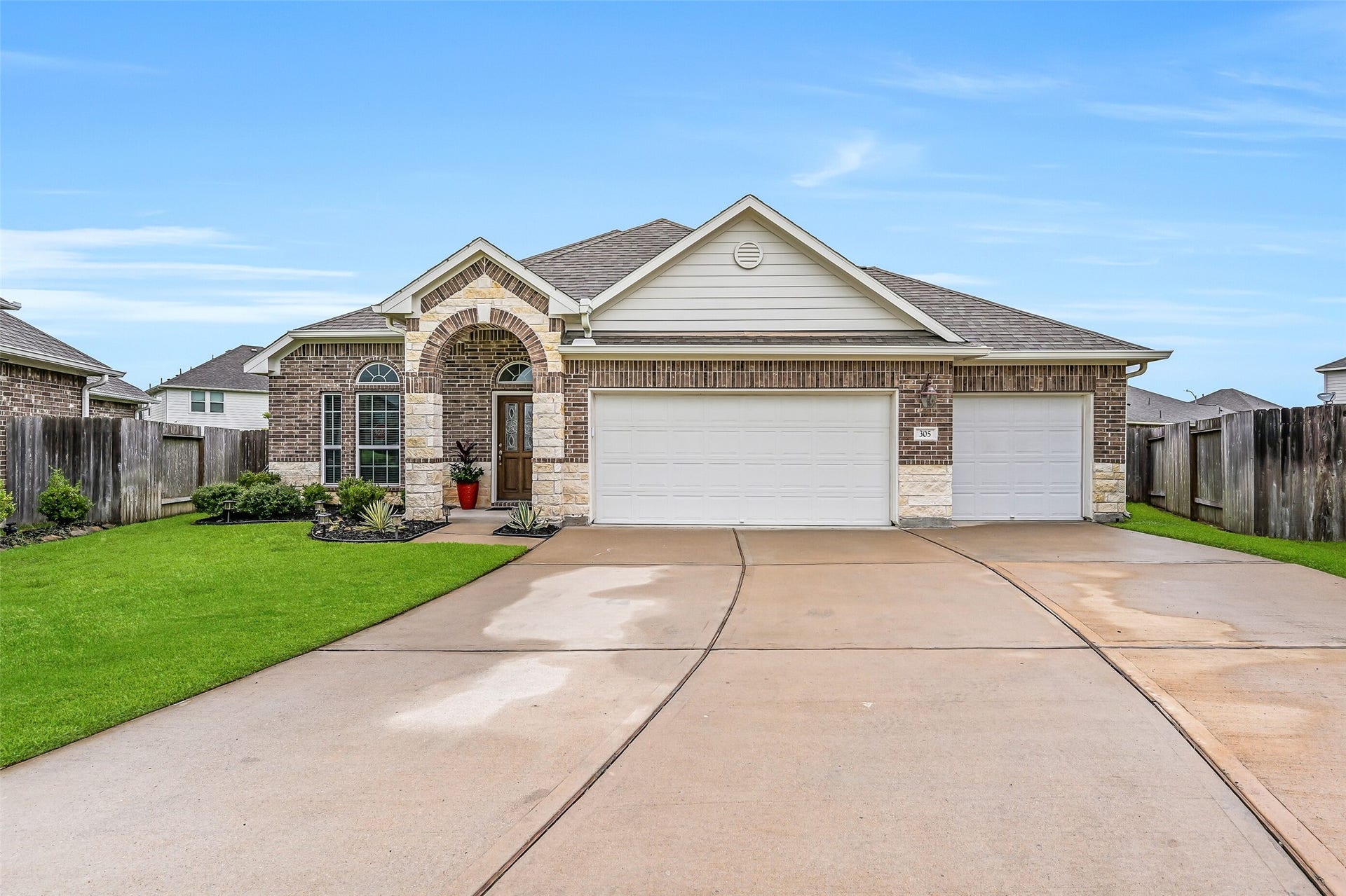 A wide driveway and beautifully maintained lawn frame the front elevation, while the oversized 15,000+ square foot homesite provides extra outdoor space that's hard to find. Conveniently located with easy access to Highway 6, Highway 35, and Highway 288.