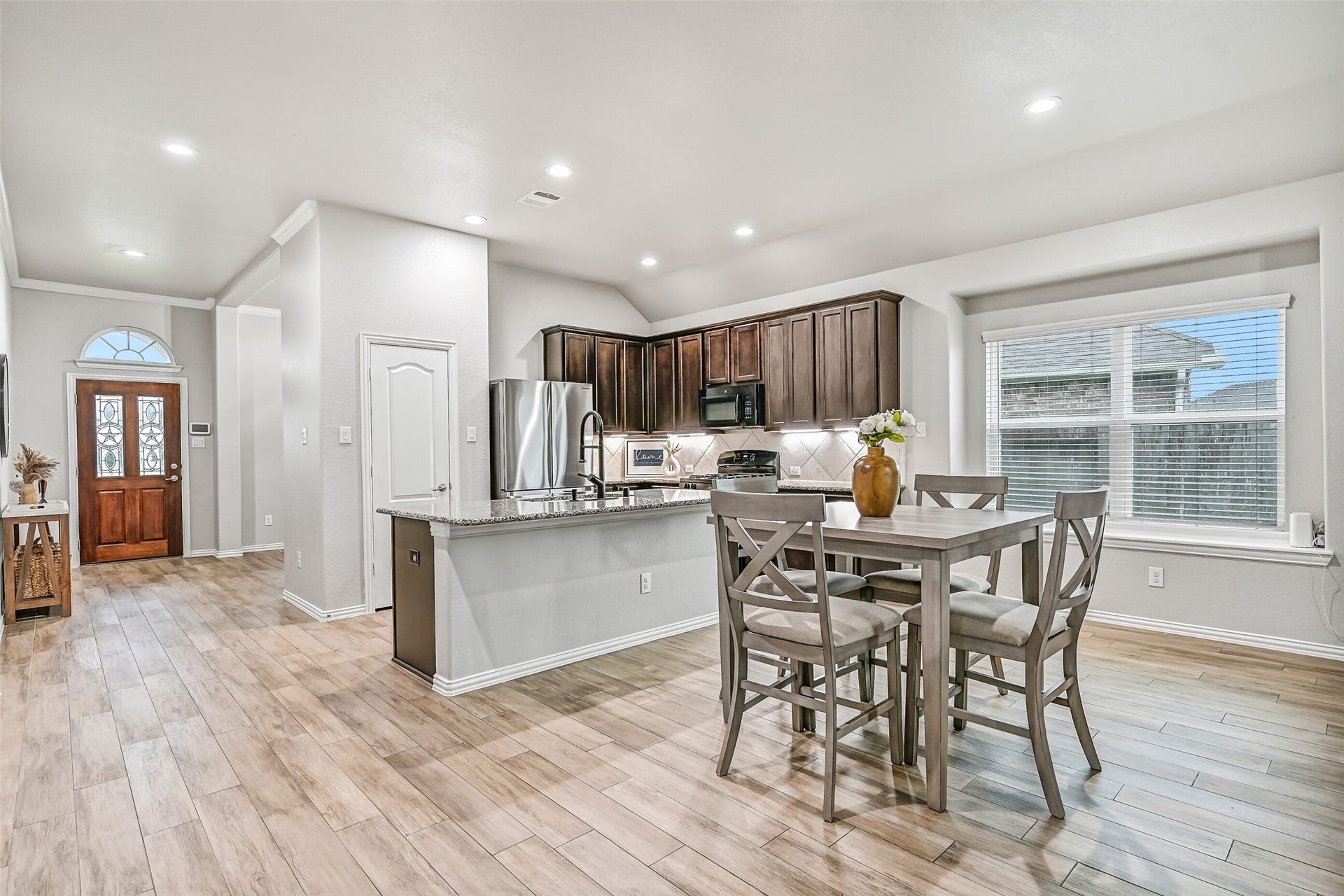 The open-concept layout effortlessly connects the kitchen, breakfast room, and living room, making everyday routines and entertaining equally enjoyable while maintaining excellent sightlines throughout the home's main living spaces.